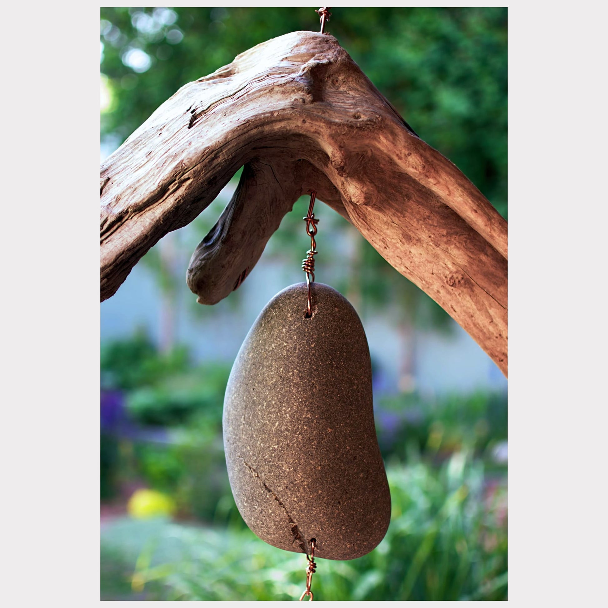 zoom detail, driftwood and beach stone wind chime