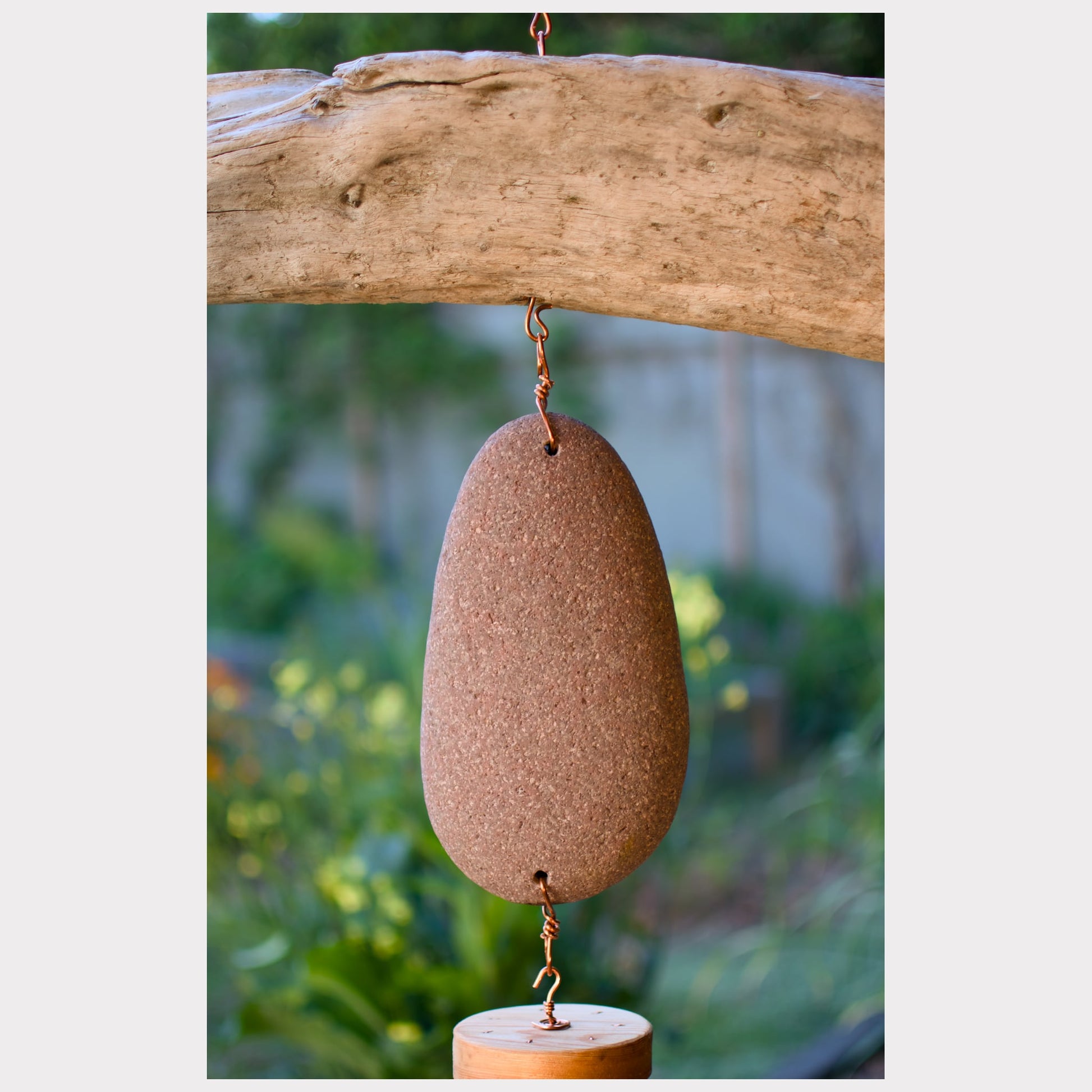 zoom detail, driftwood and beach stone wind chime