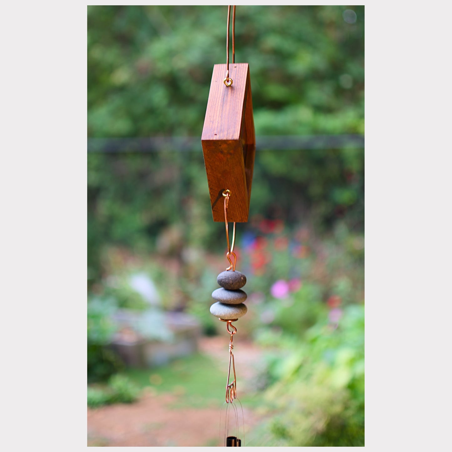 Sideview, kaleidoscope wind chime with beach pebbles and three aluminum chimes.