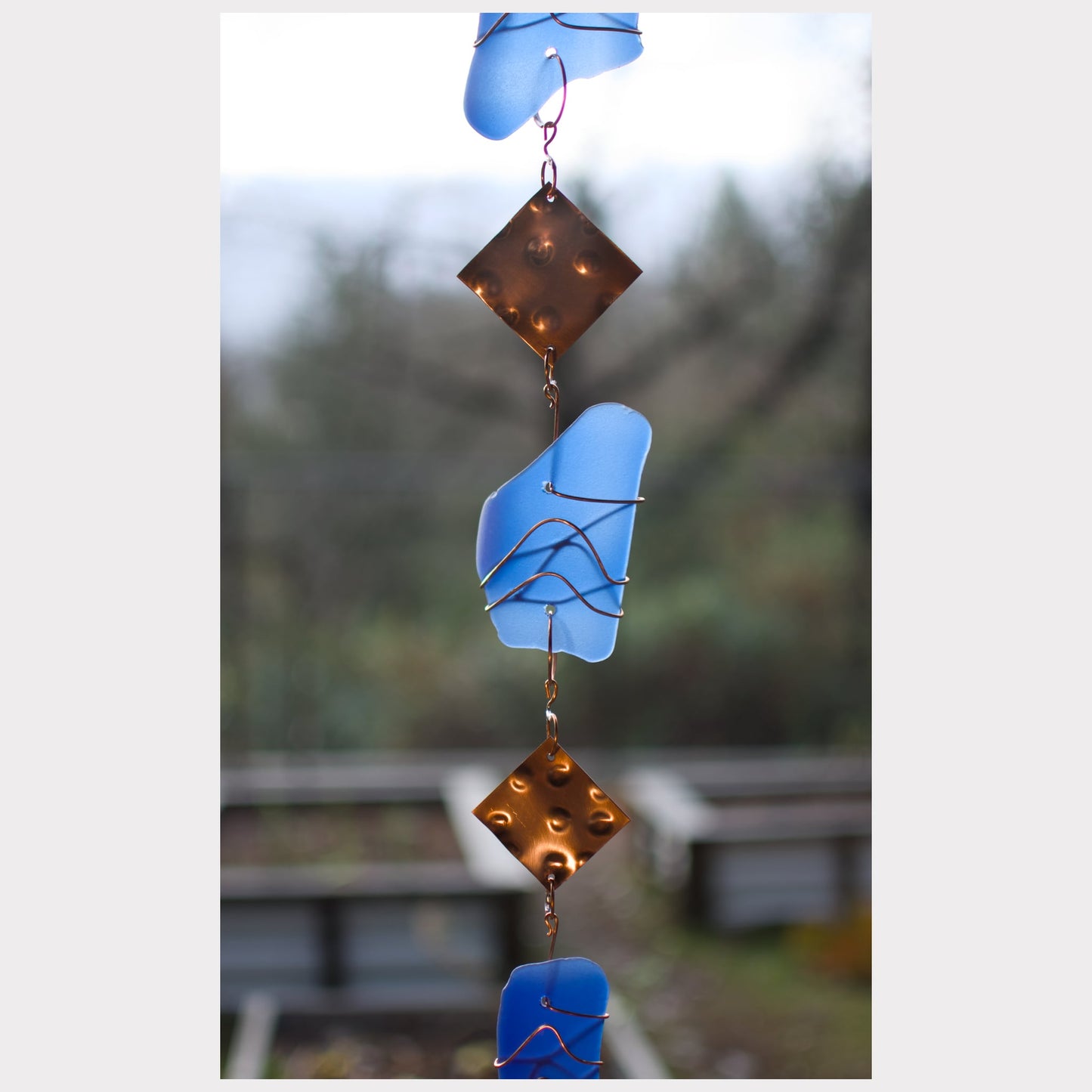 zoom detail, glass and copper wind chime