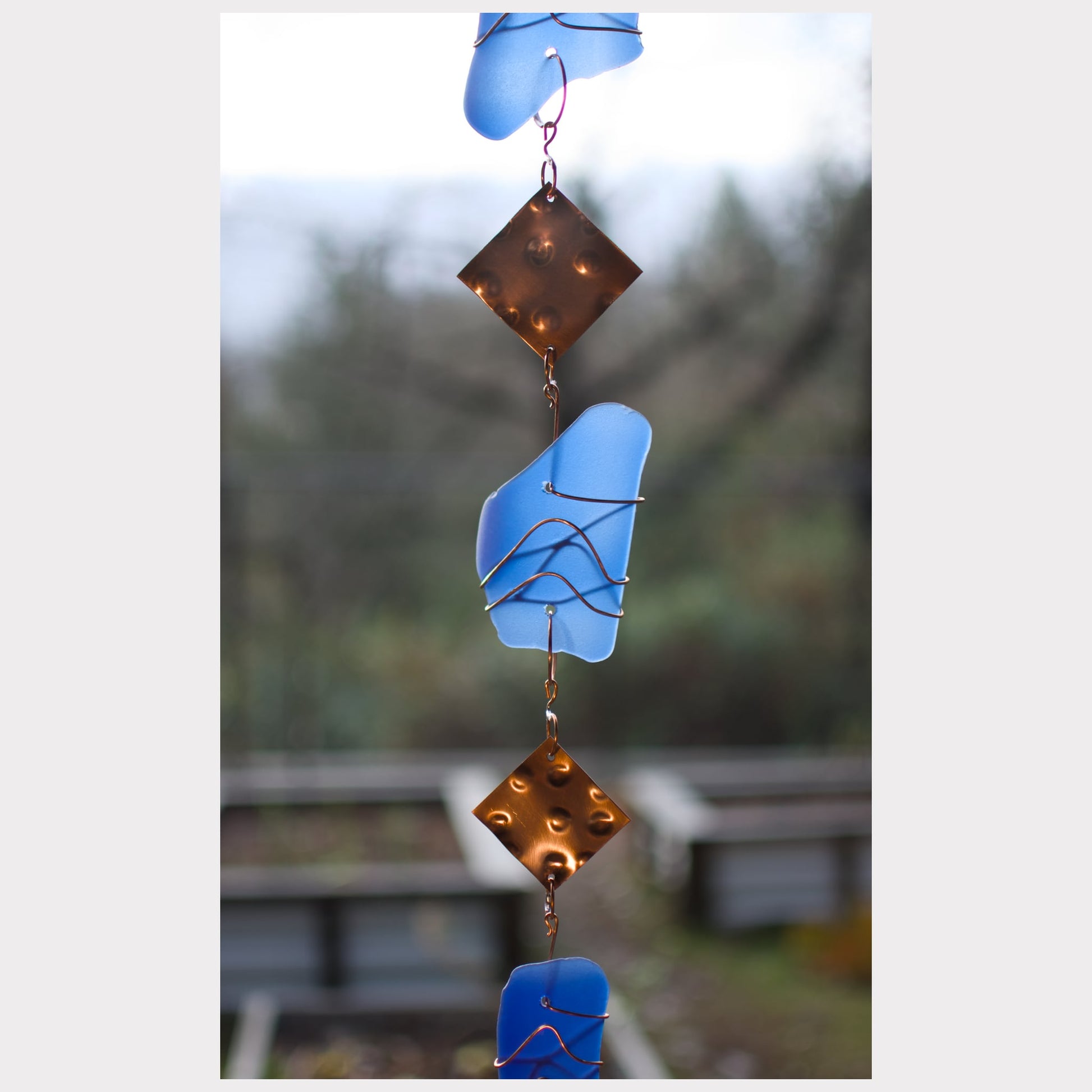 zoom detail, glass and copper wind chime