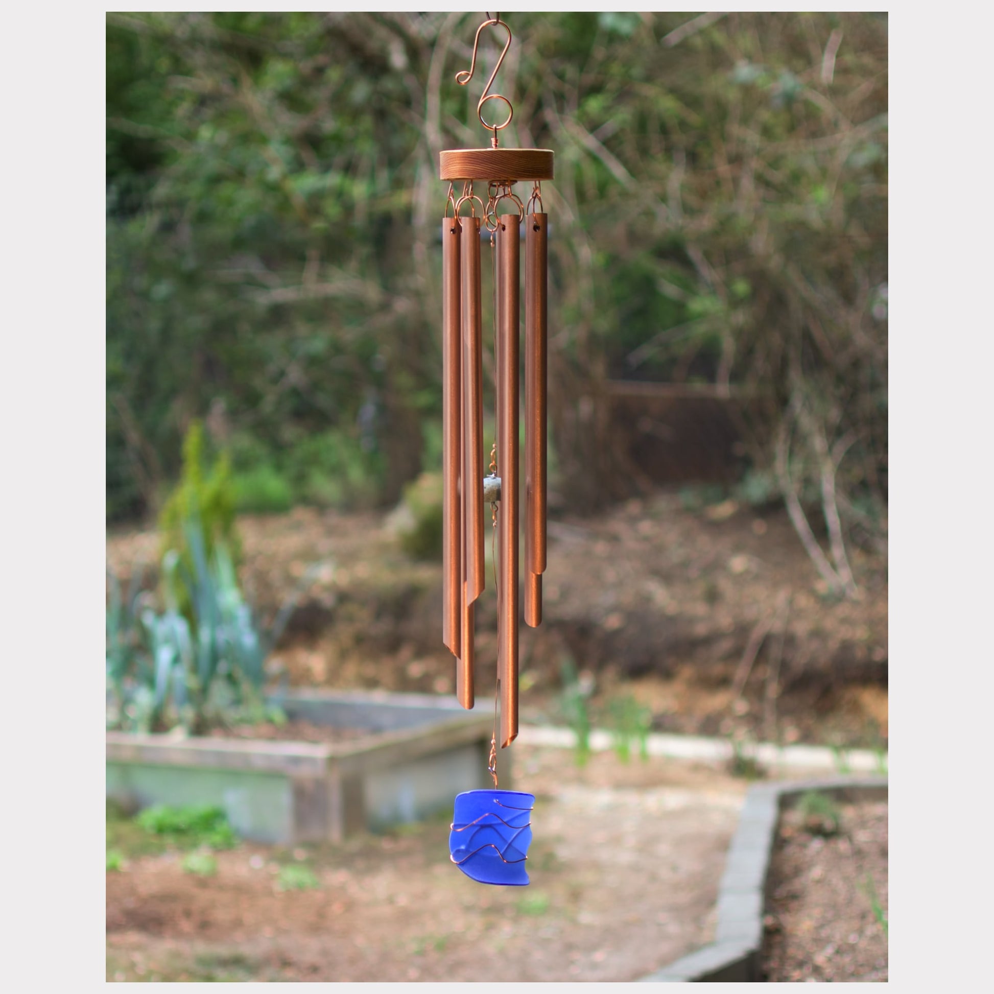 Genuine copper wind chime with an artist-made cobalt blue copper wire wrapped windsail, and seven chimes.