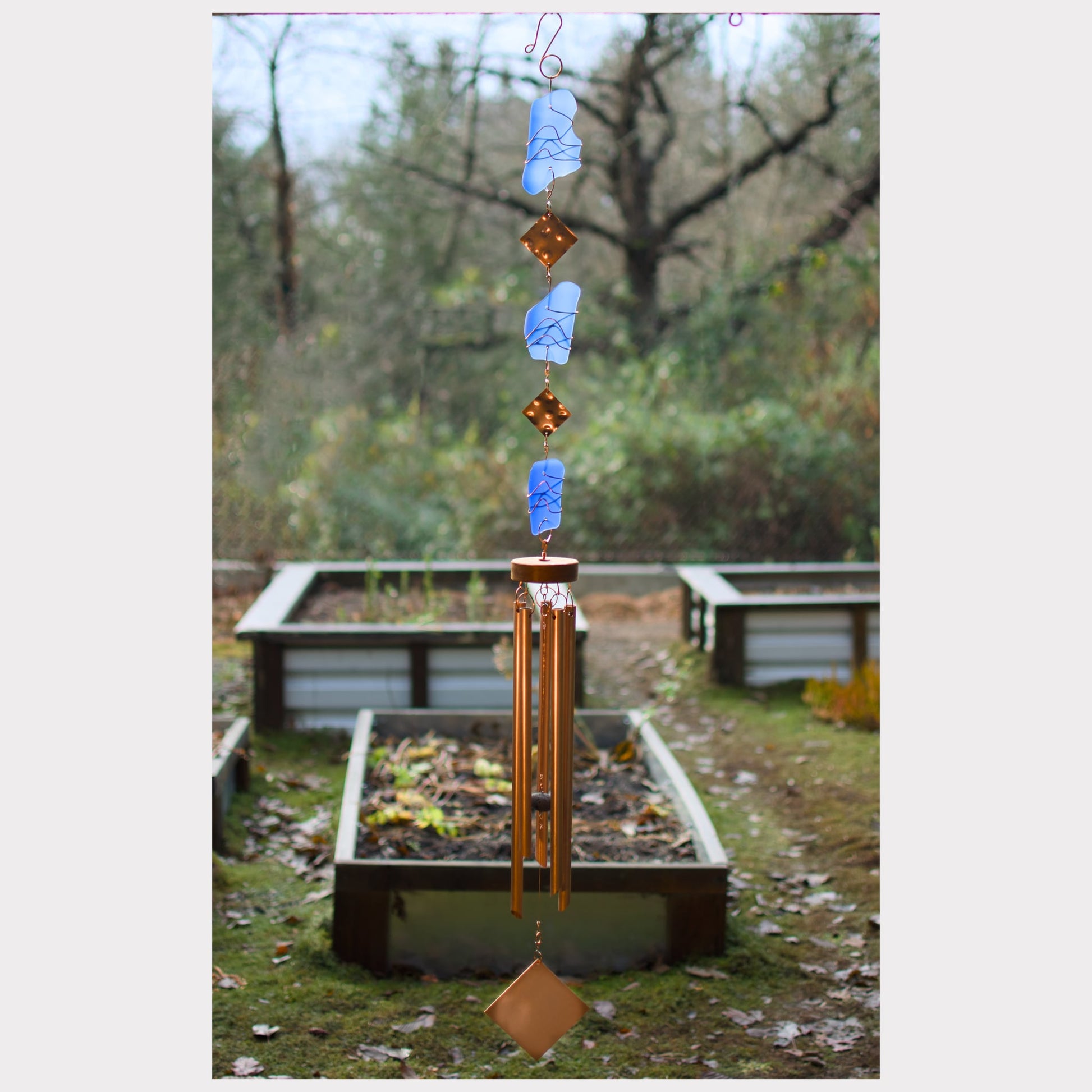 Large handcrafted copper wind chime with five chimes and cobalt blue glass.