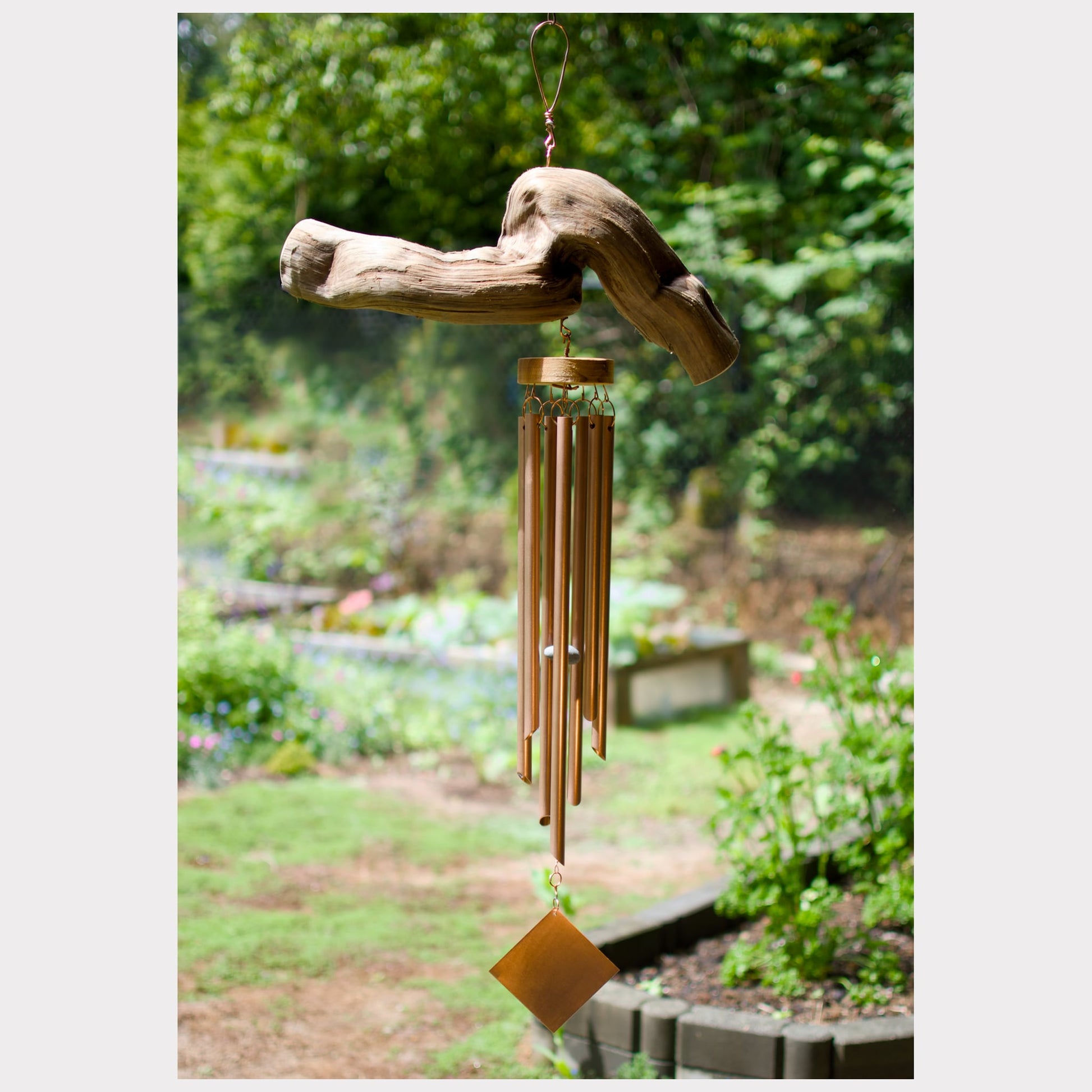 Natural driftwood wind chime featuring seven genuine copper chimes.