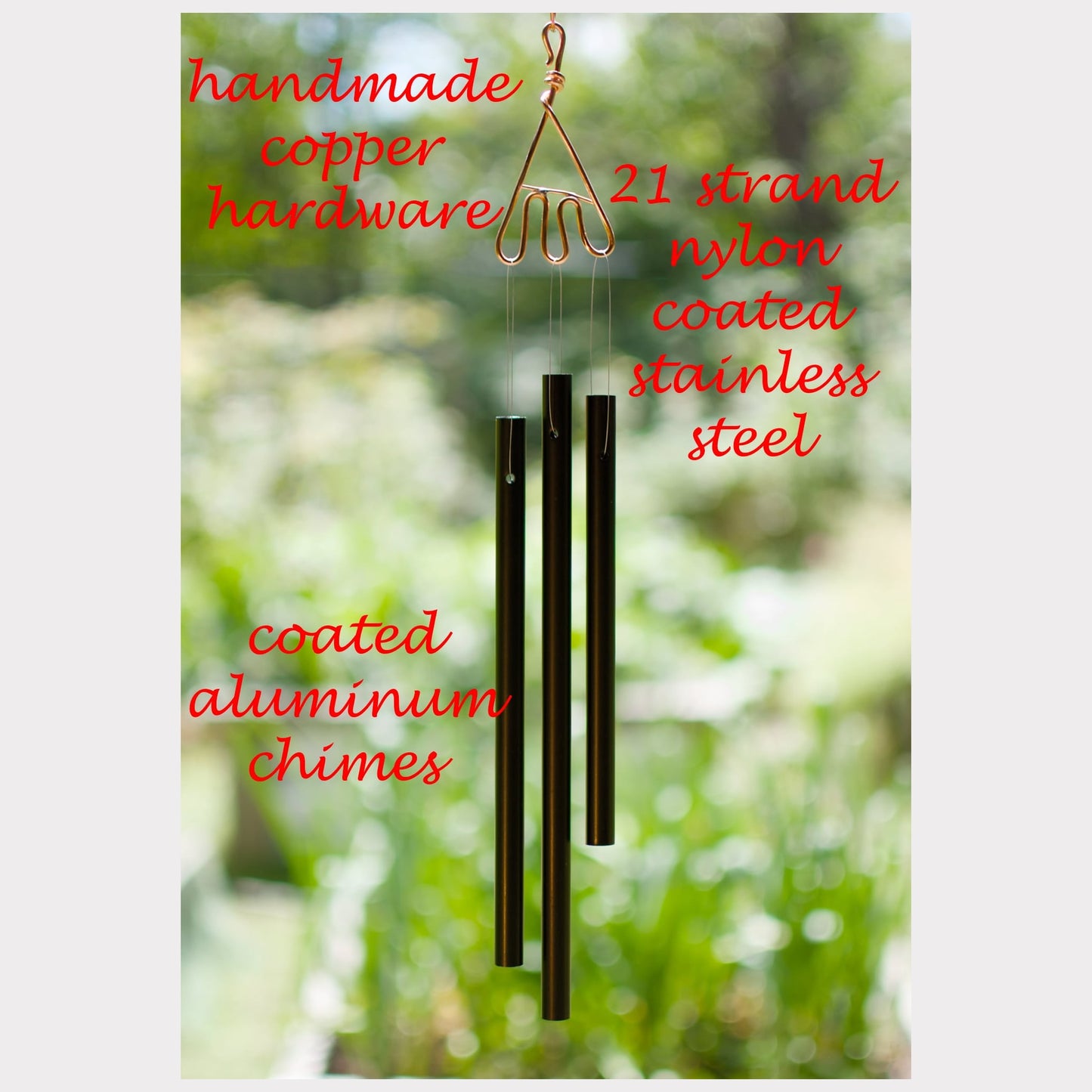 Handmade copper hardware coated aluminum  wind chime with text detailing material specifications against a blurred green background.
