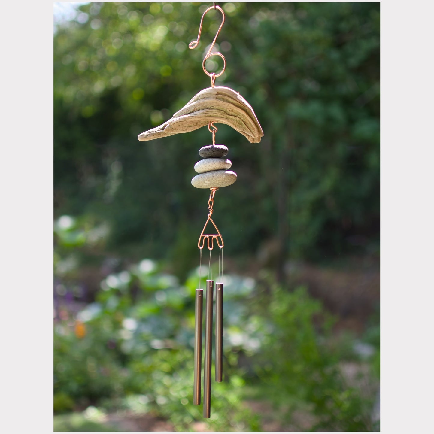 Driftwood and beach stone wind chime with three antiqued brass chimes.