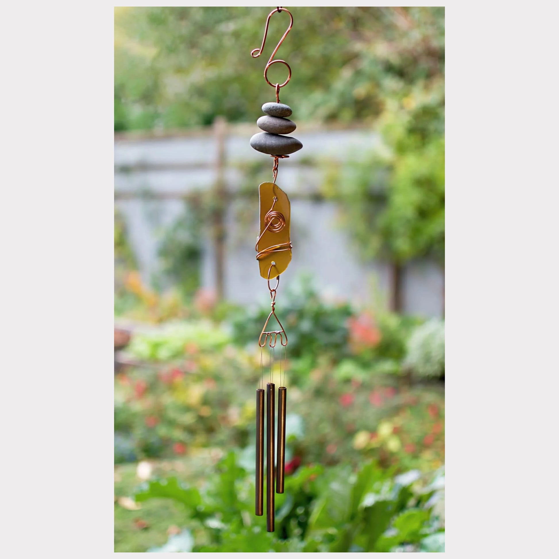 Handmade zen beach stone and sea glass wind chime with three brass chimes.