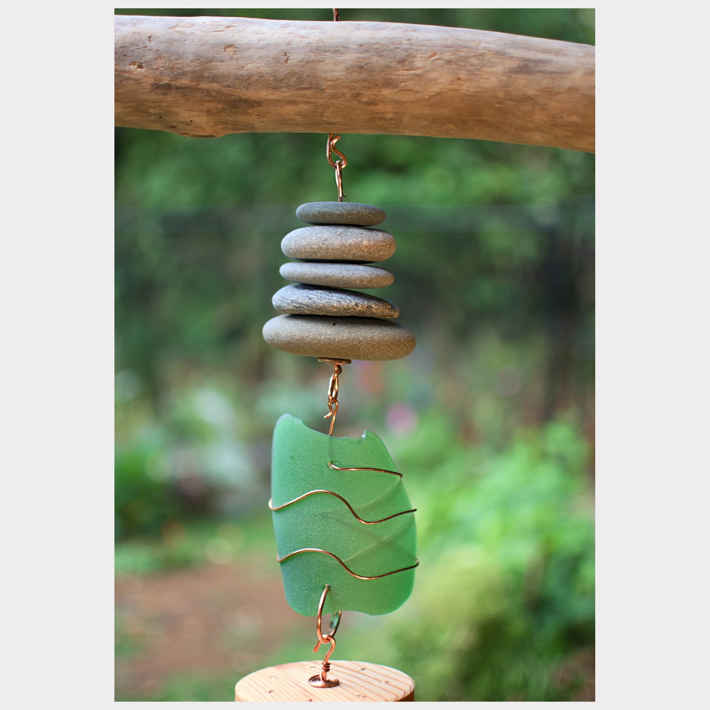 Zoom detail, driftwood, beach stone, sea glass wind chime.