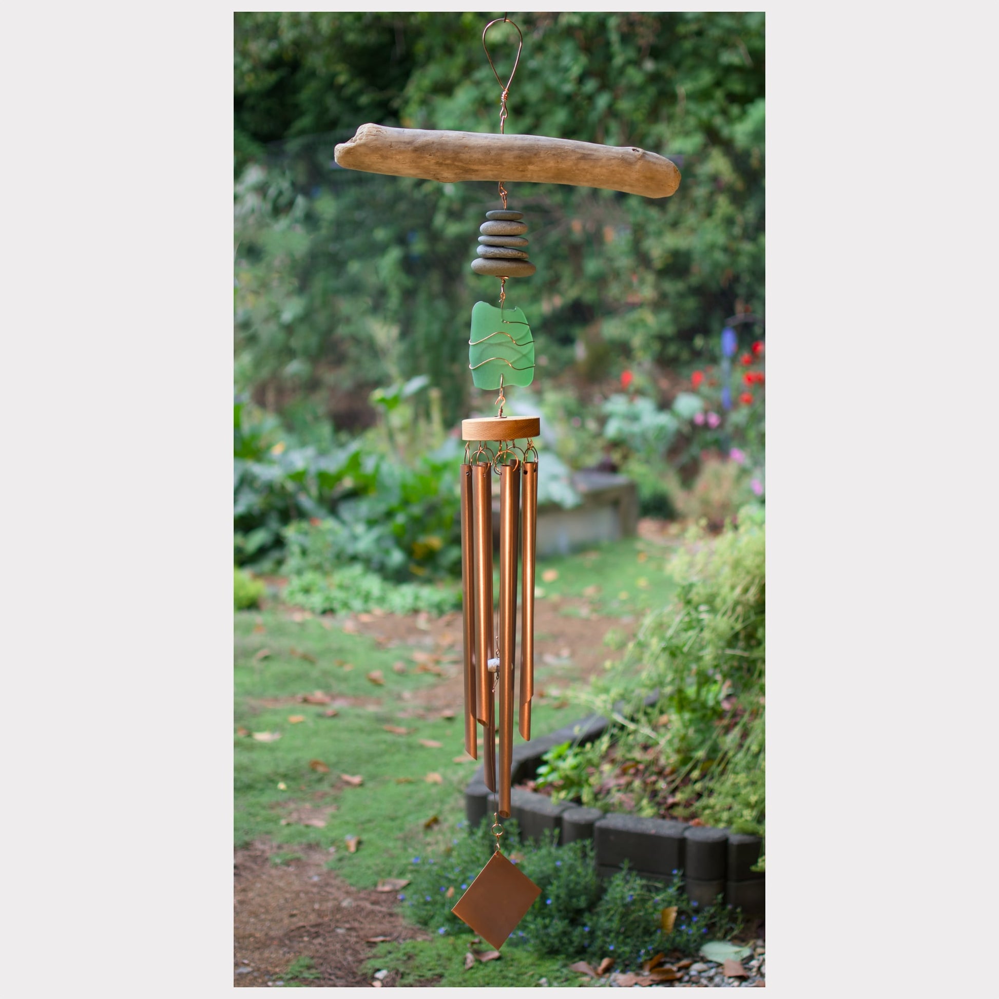 Wind chime featuring driftwood, beach stones, sea glass, and 7 genuine copper chimes.