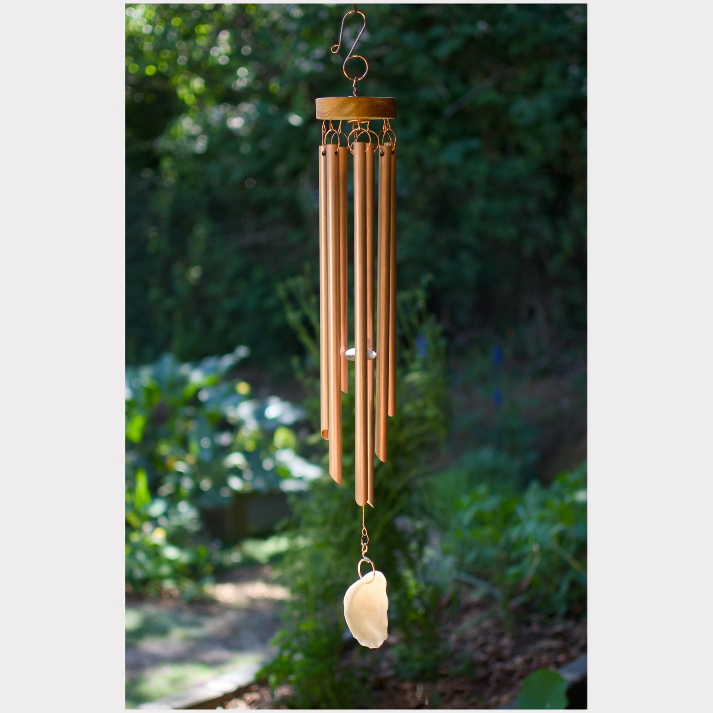 Handmade wind chime featuring 7 genuine copper chimes and an oyster half shell windsail.