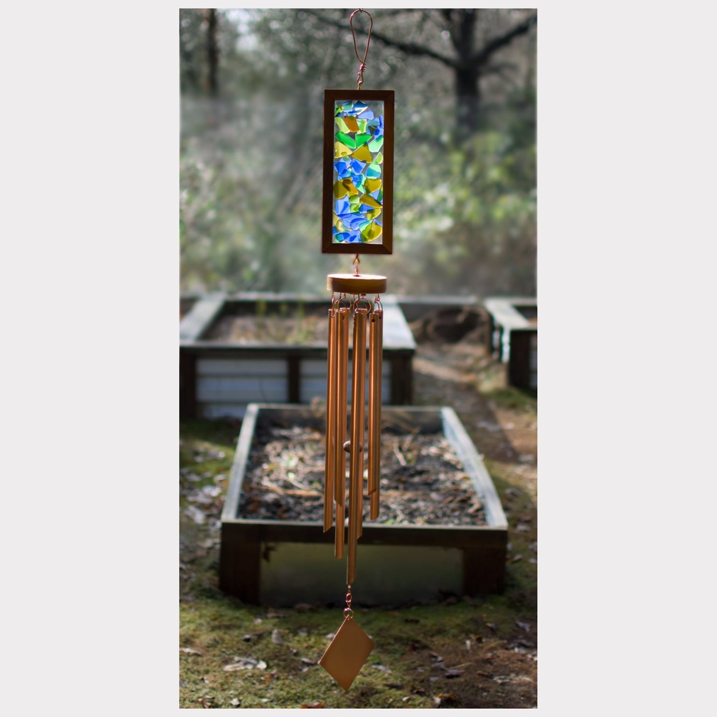 Large kaleidoscope wind chime featuring artist-made sea glass and seven copper chimes.