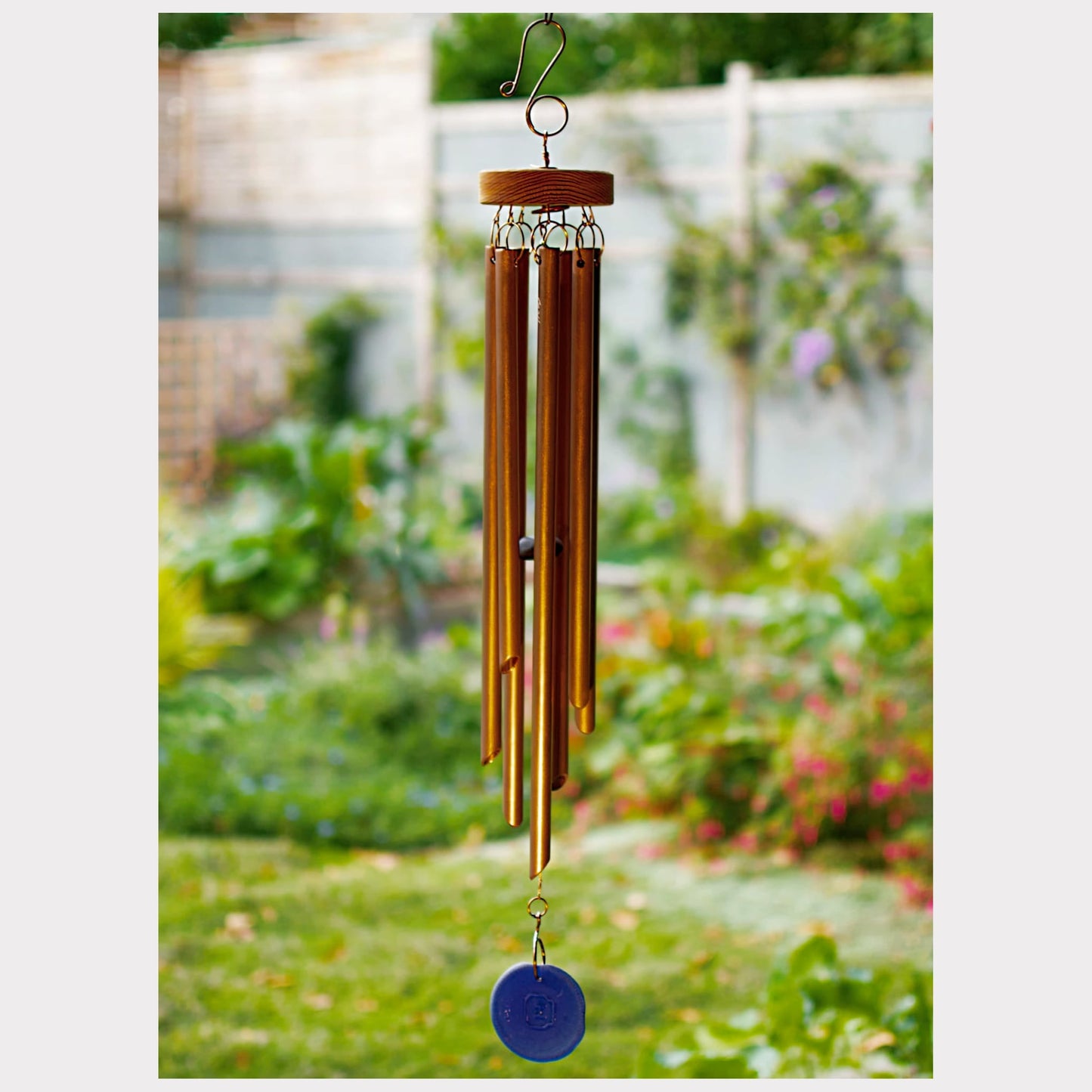 Handcrafted copper wind chime with 7 chimes and an artist-made cobalt blue sea glass windsail.