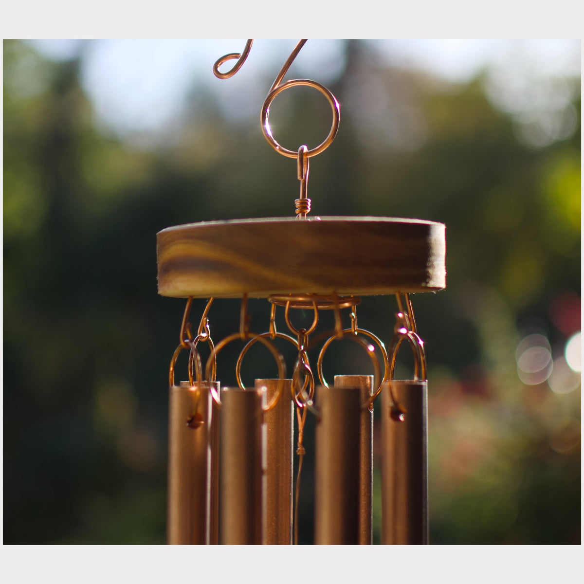 Detail image of the copper hardware and cedar roundel of a handcrafted wind chime.