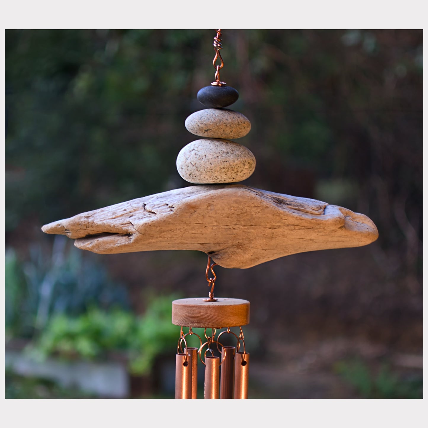 detail, zen beach stone and driftwood copper wind chime