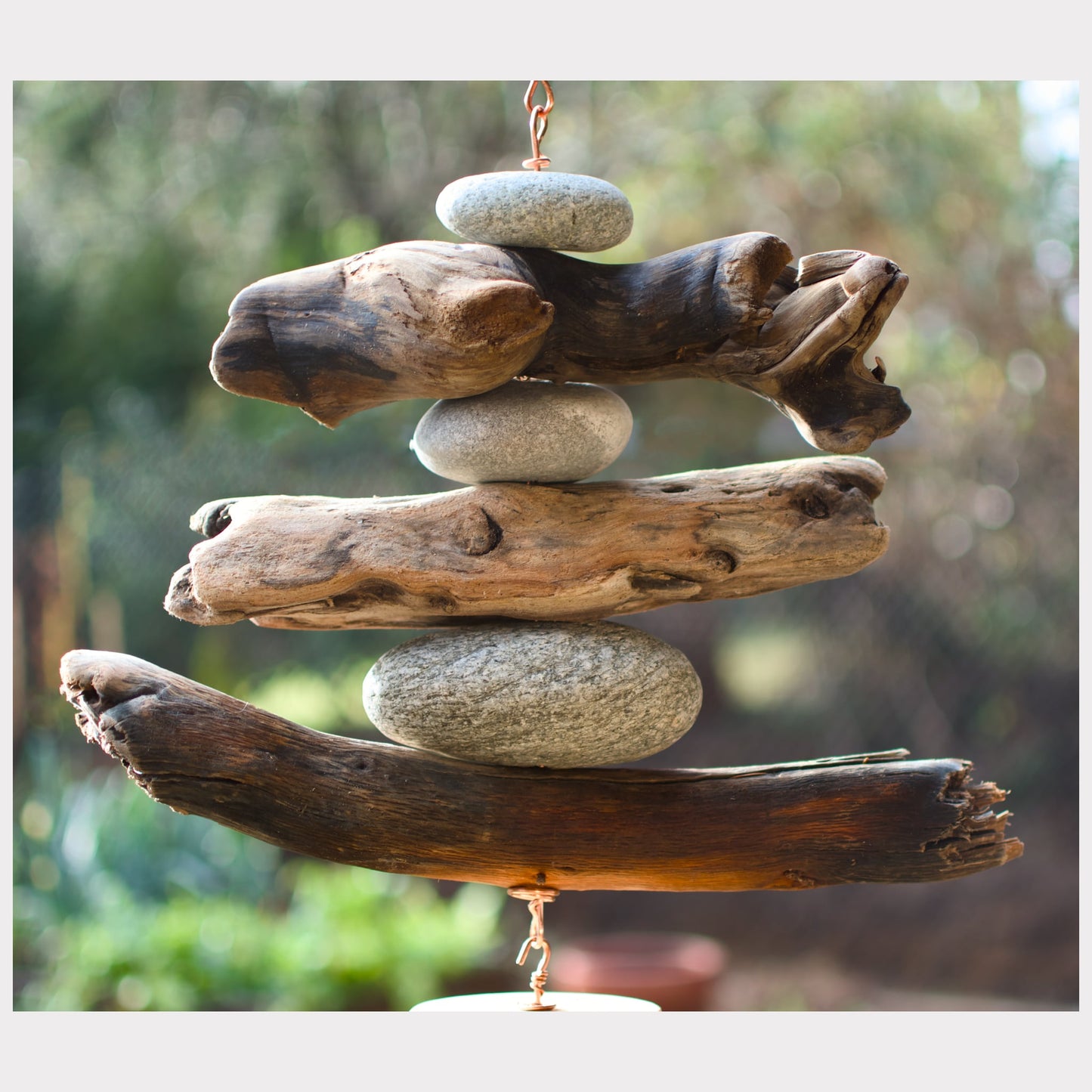 detail, driftwood and beach stone wind chime