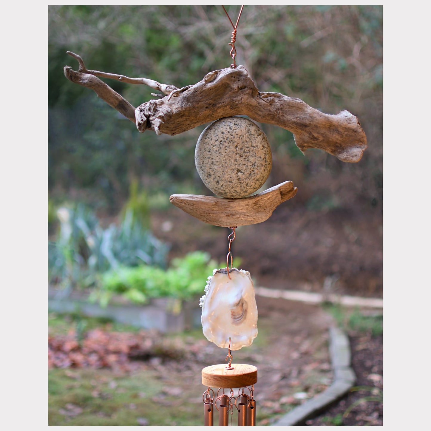 detail, large driftwood, beach stone, oyster shell wind chime