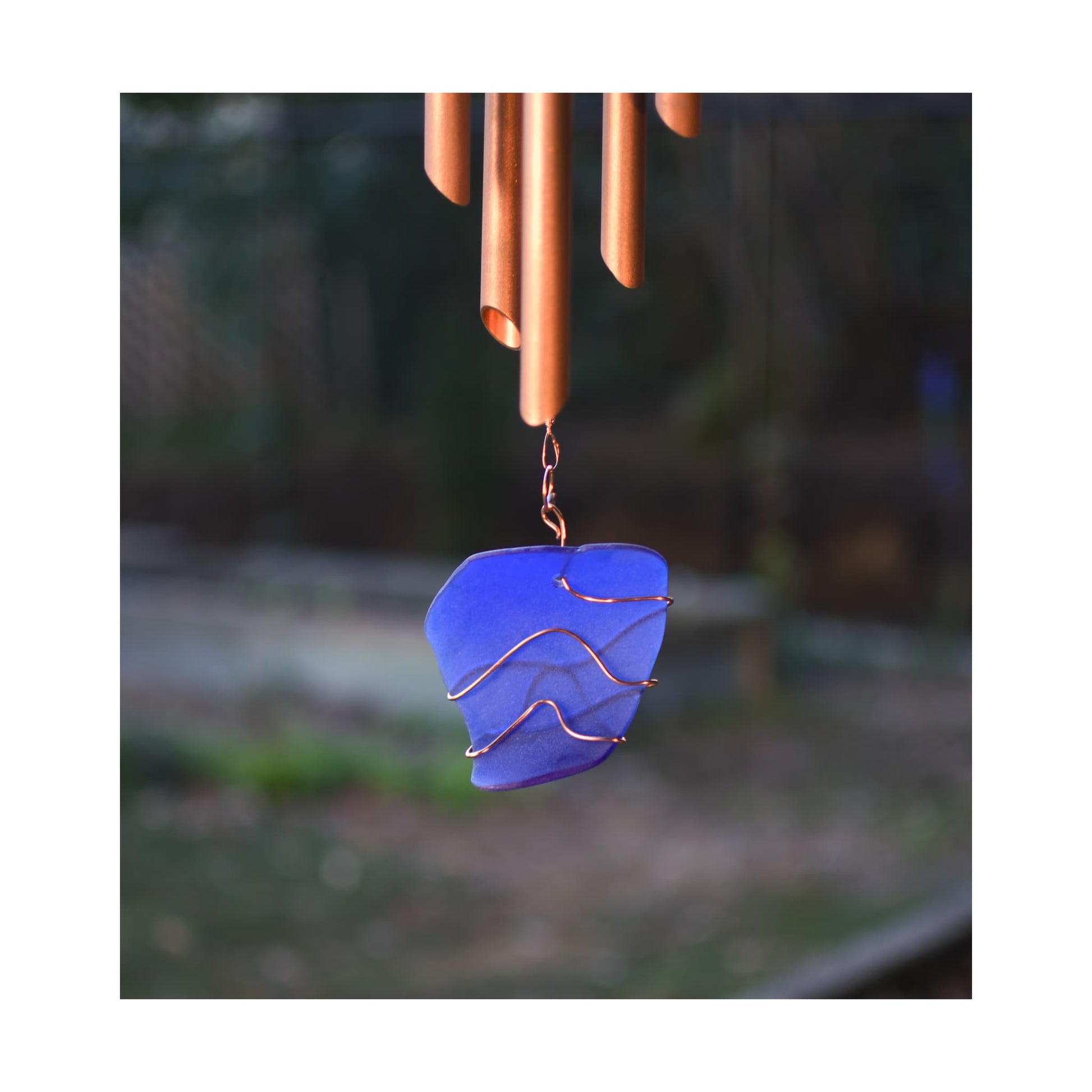 Detail, cobalt blue sea glass copper-wrapped windsail for a large wind chime.