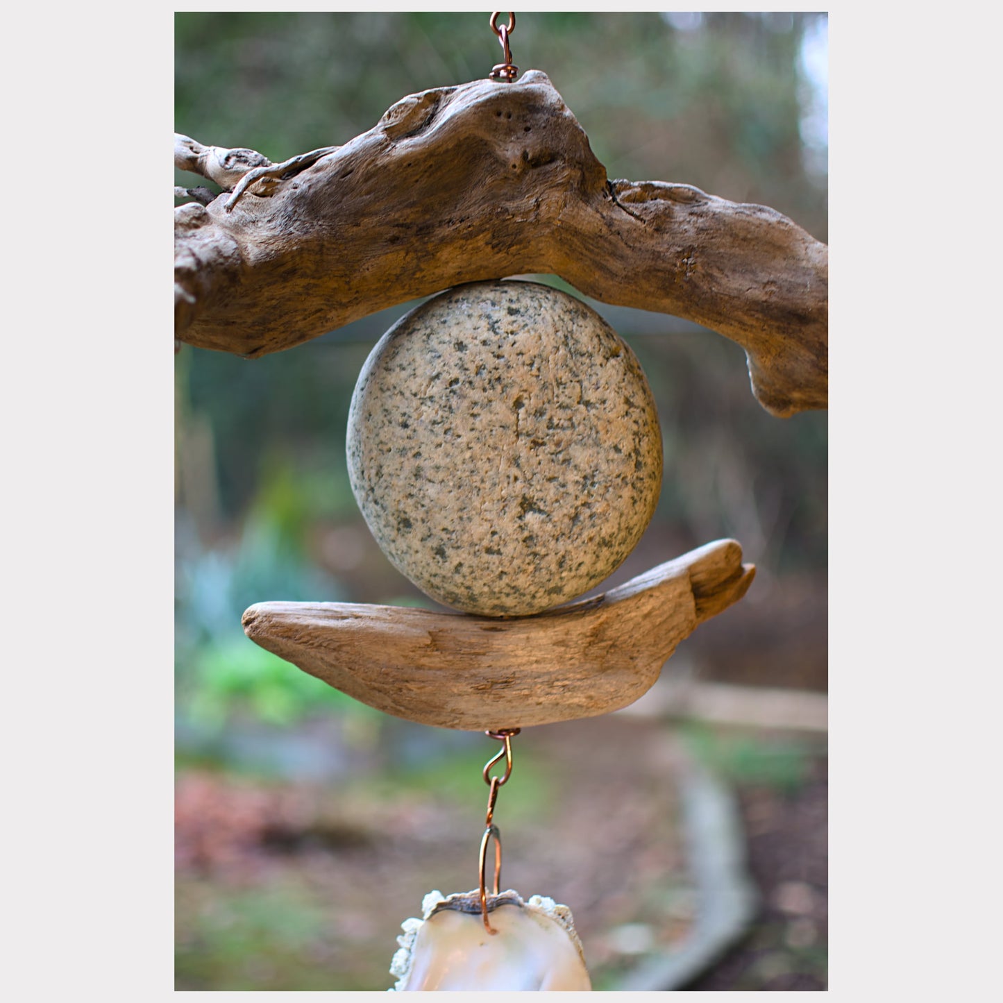 zoom detail, driftwood and beach stone wind chime