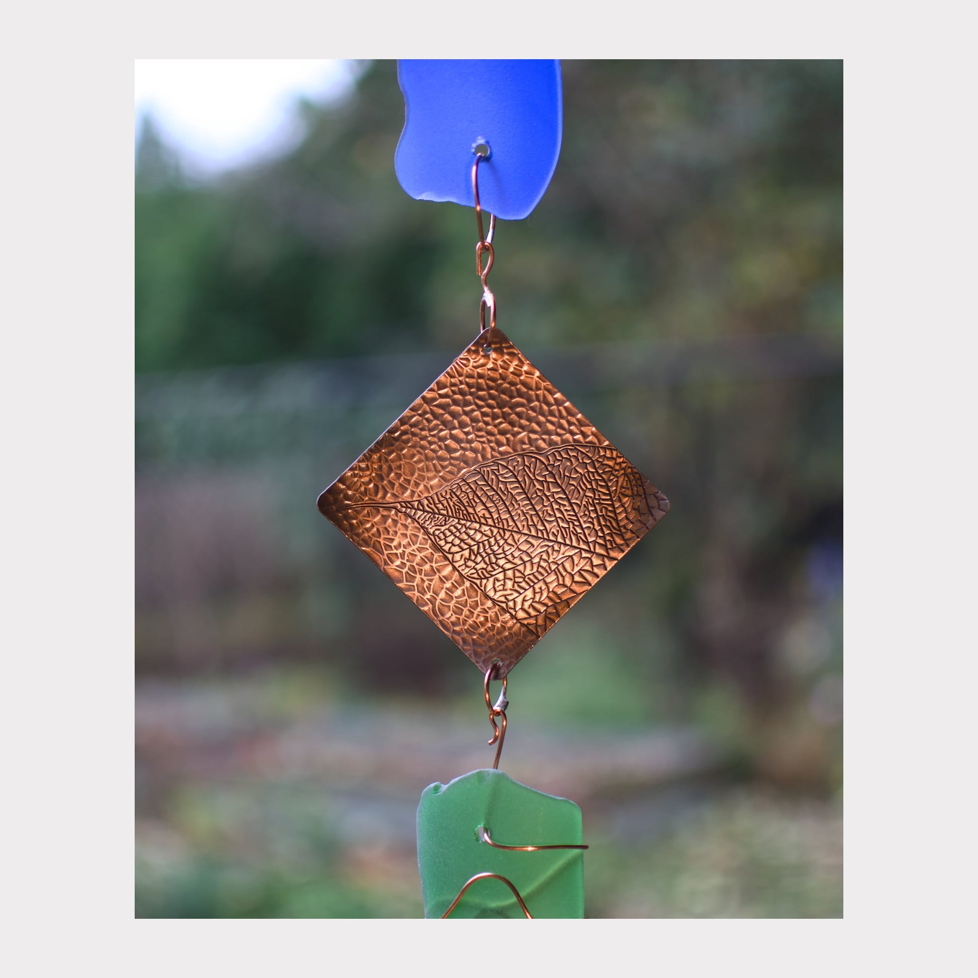 Zoom detail, glass and copper wind chime.