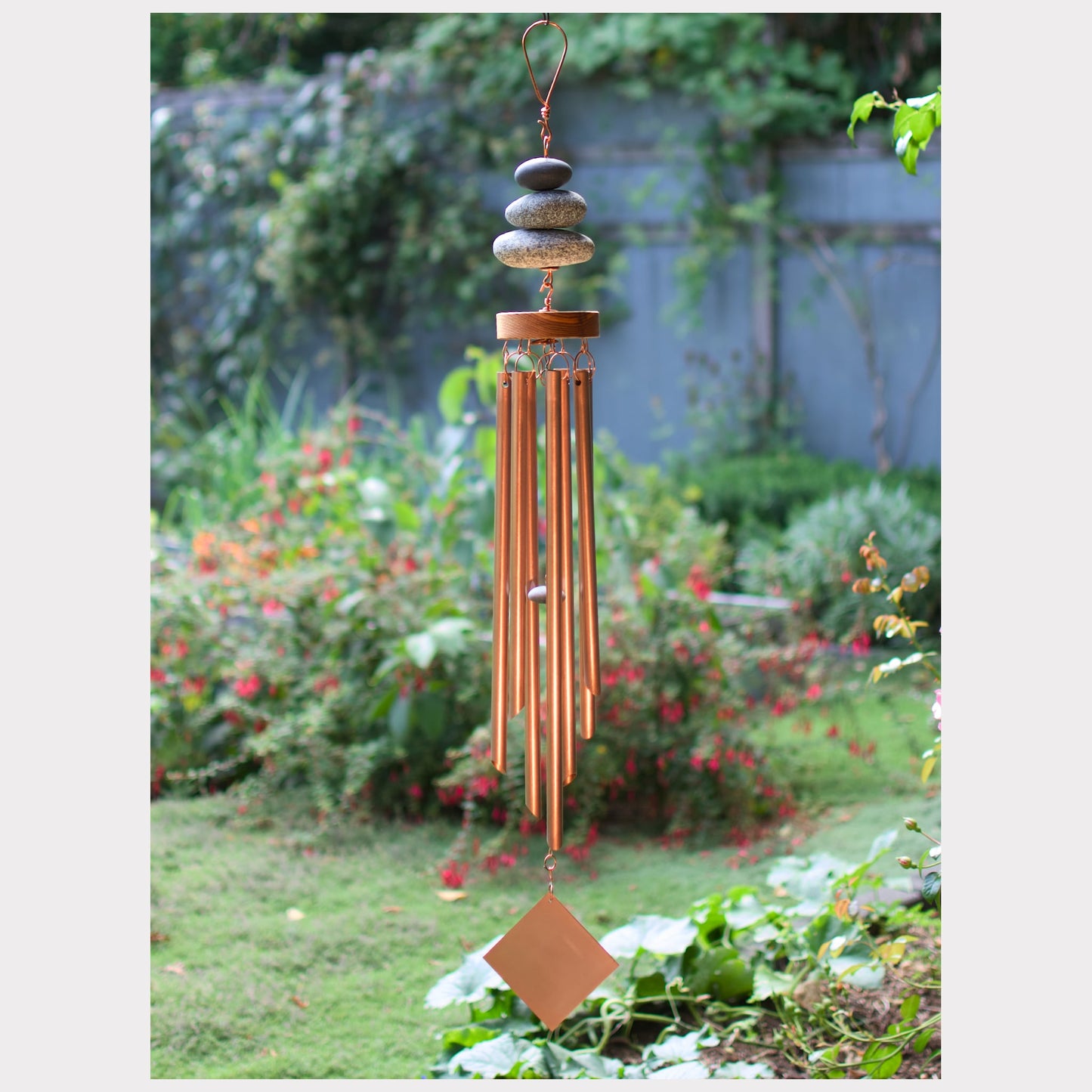 Large zen wind chime with three natural beach stones and seven copper chimes.