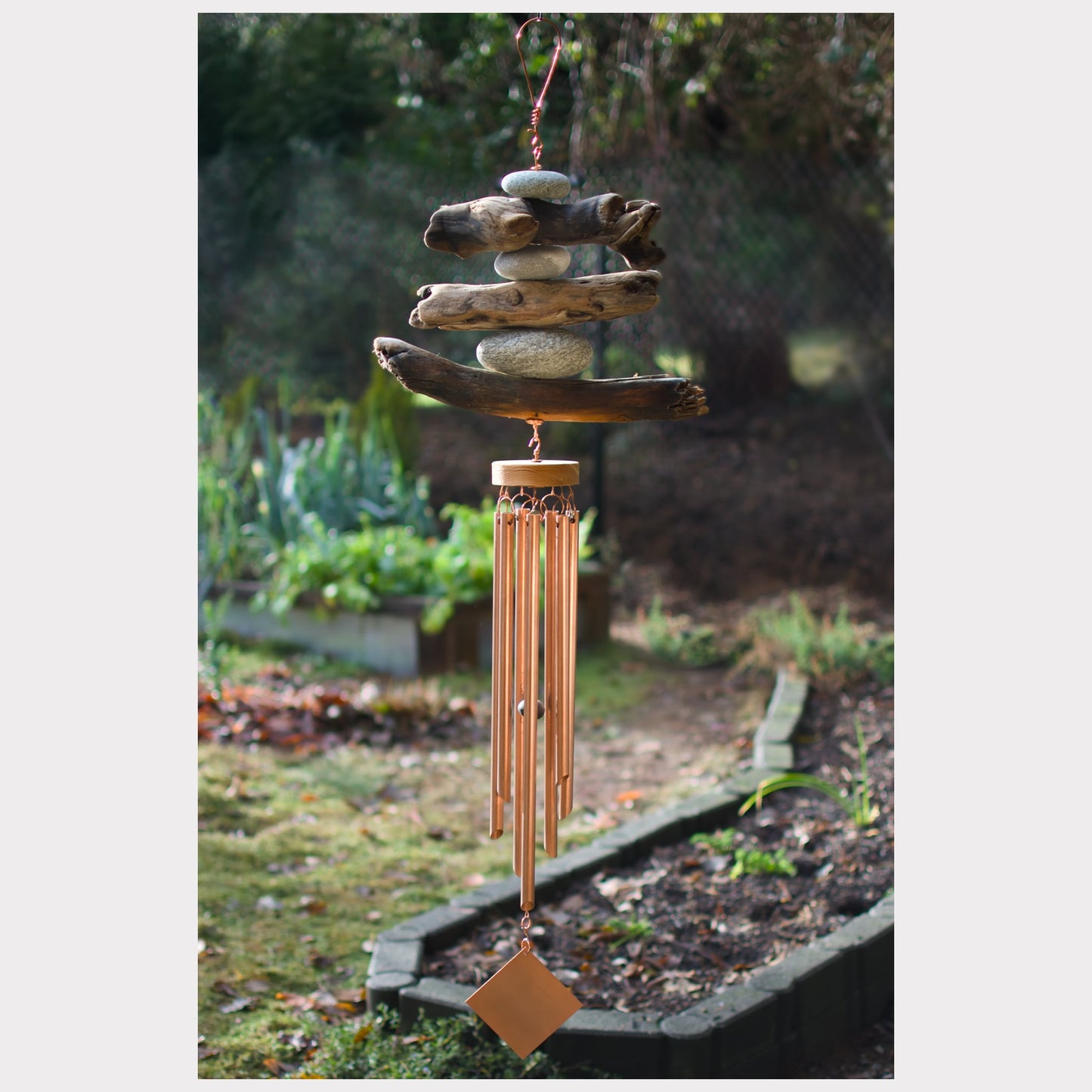 Large driftwood and beach stone wind chime with seven copper chimes.