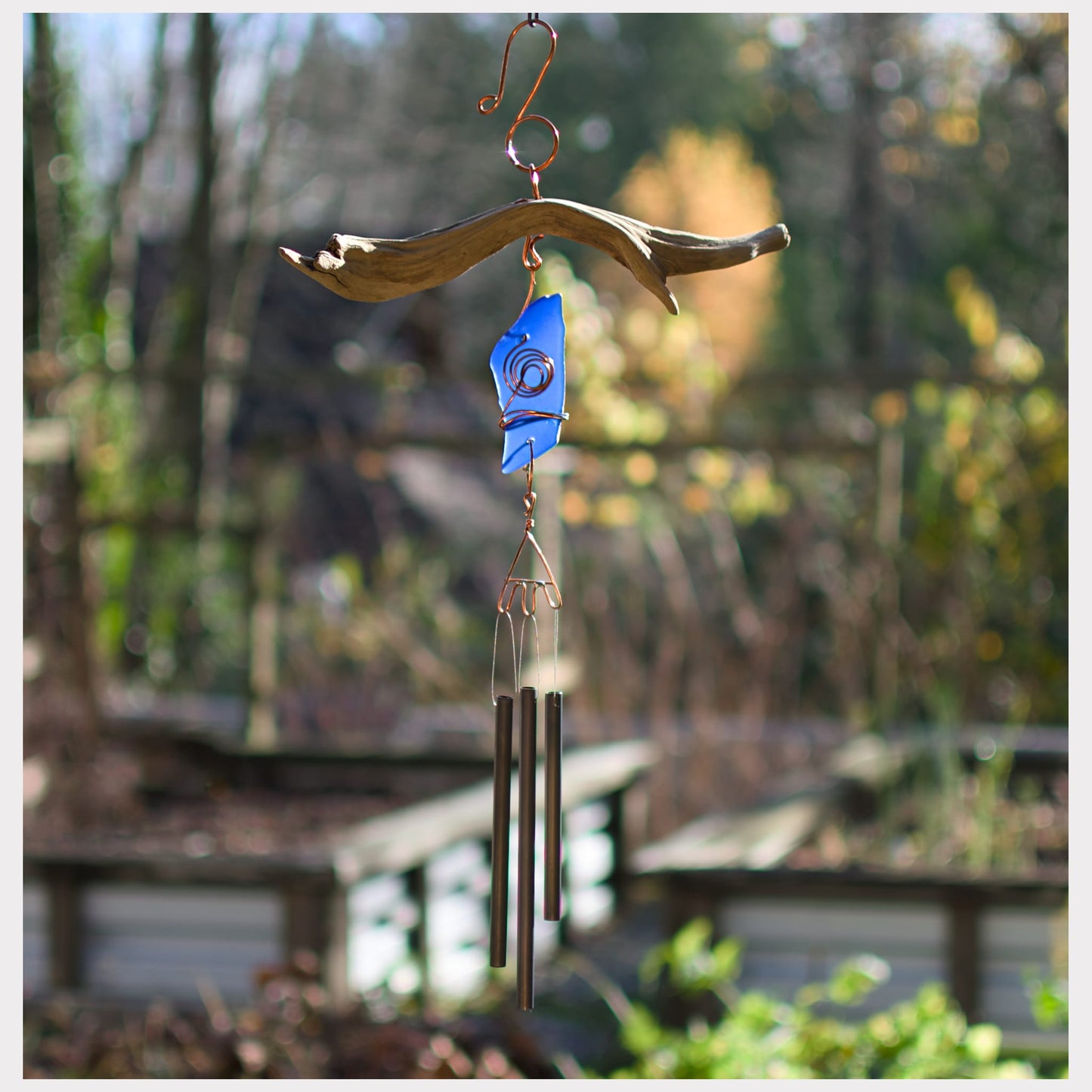 Natural driftwood with cobalt blue beach glass wind chime.