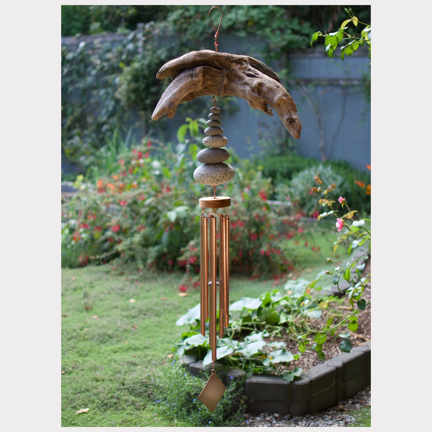 Large natural driftwood and beach stone wind chime with seven copper chimes.