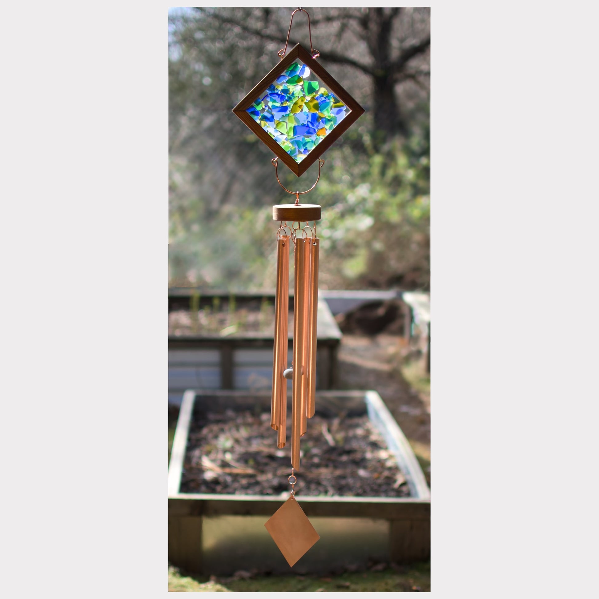 Kaleidoscope wind chime featuring artist-made beach glass and five copper chimes.