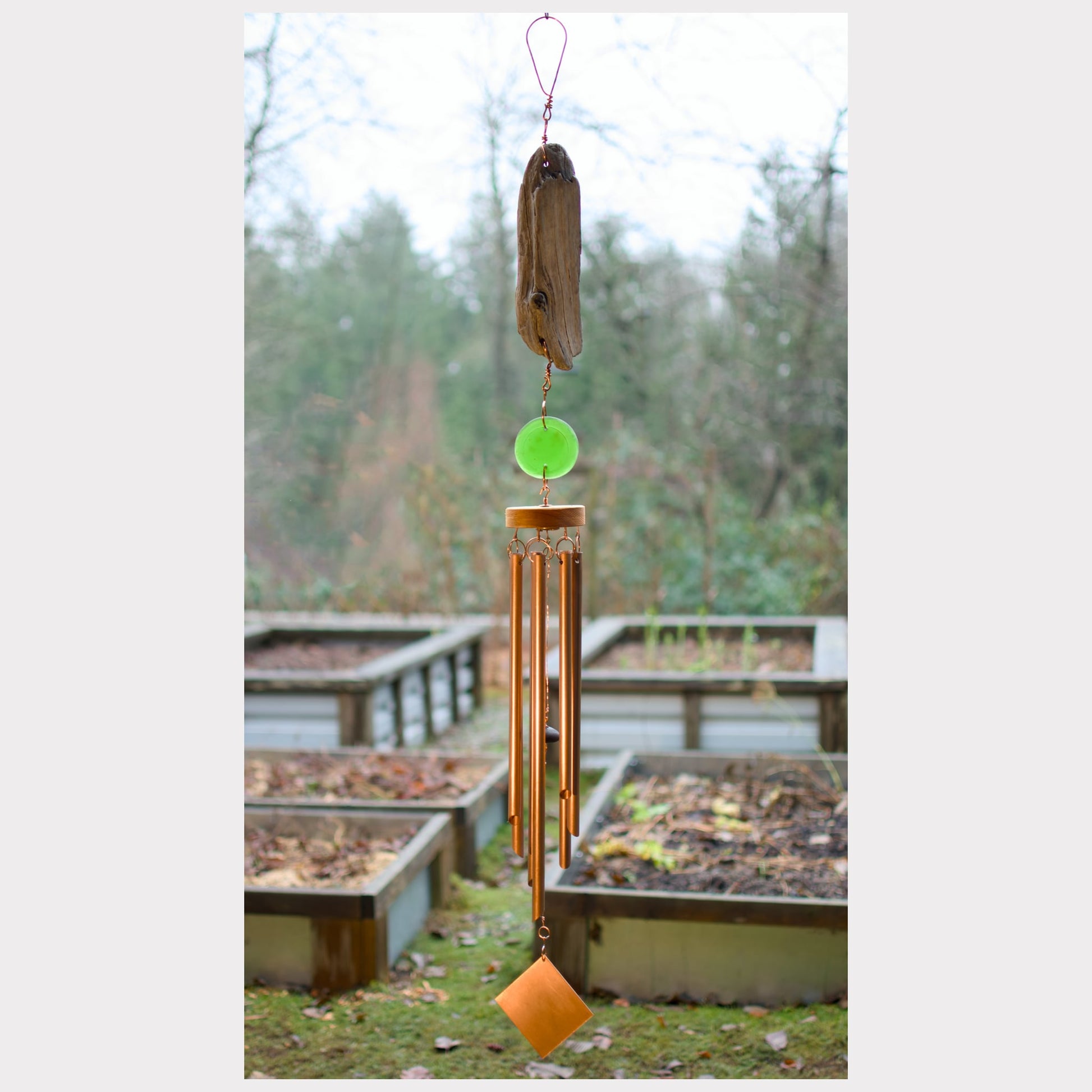 Natural driftwood and sea glass wind chime with seven copper chimes.