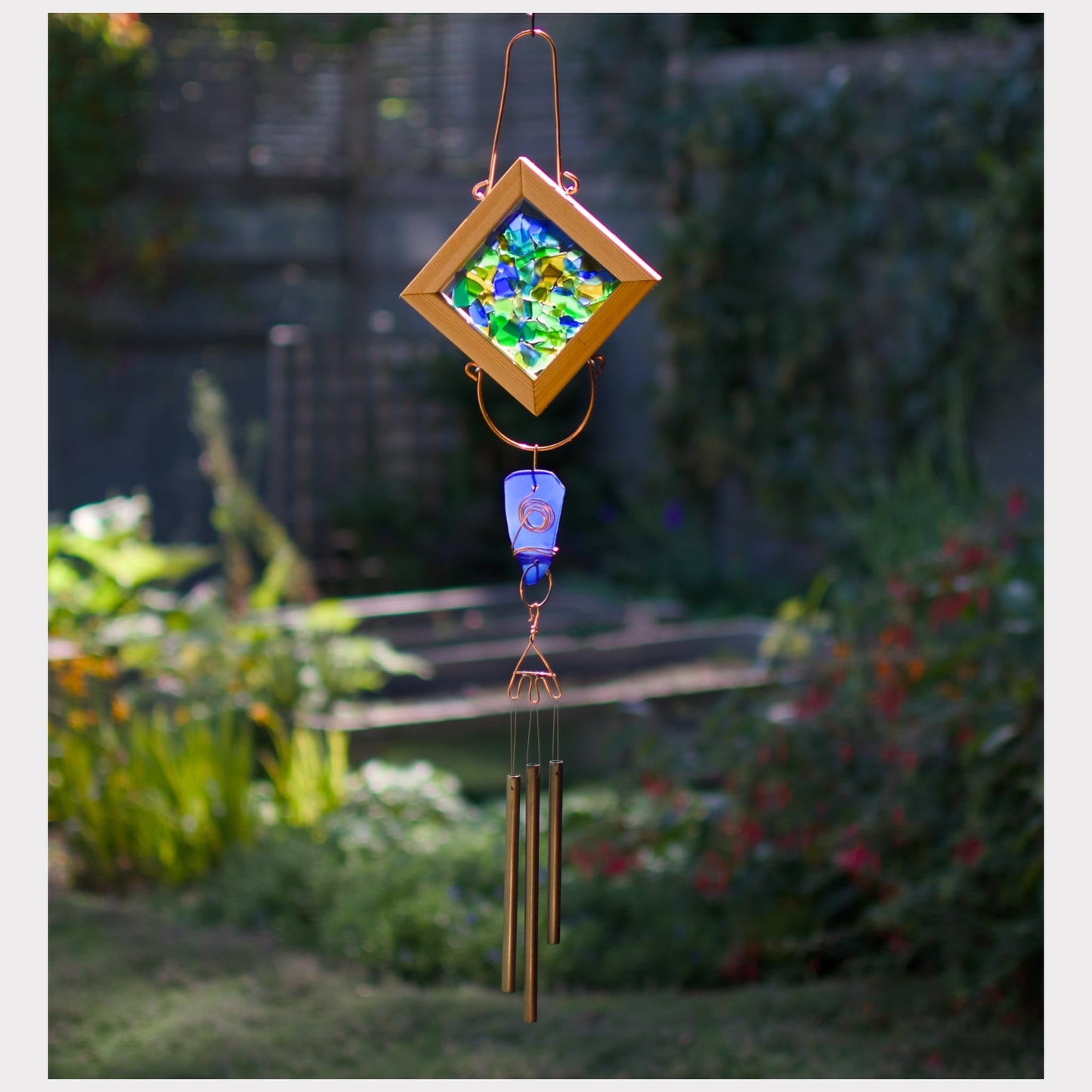 Artist-made sea glass kaleidoscope wind chime with three brass chimes.