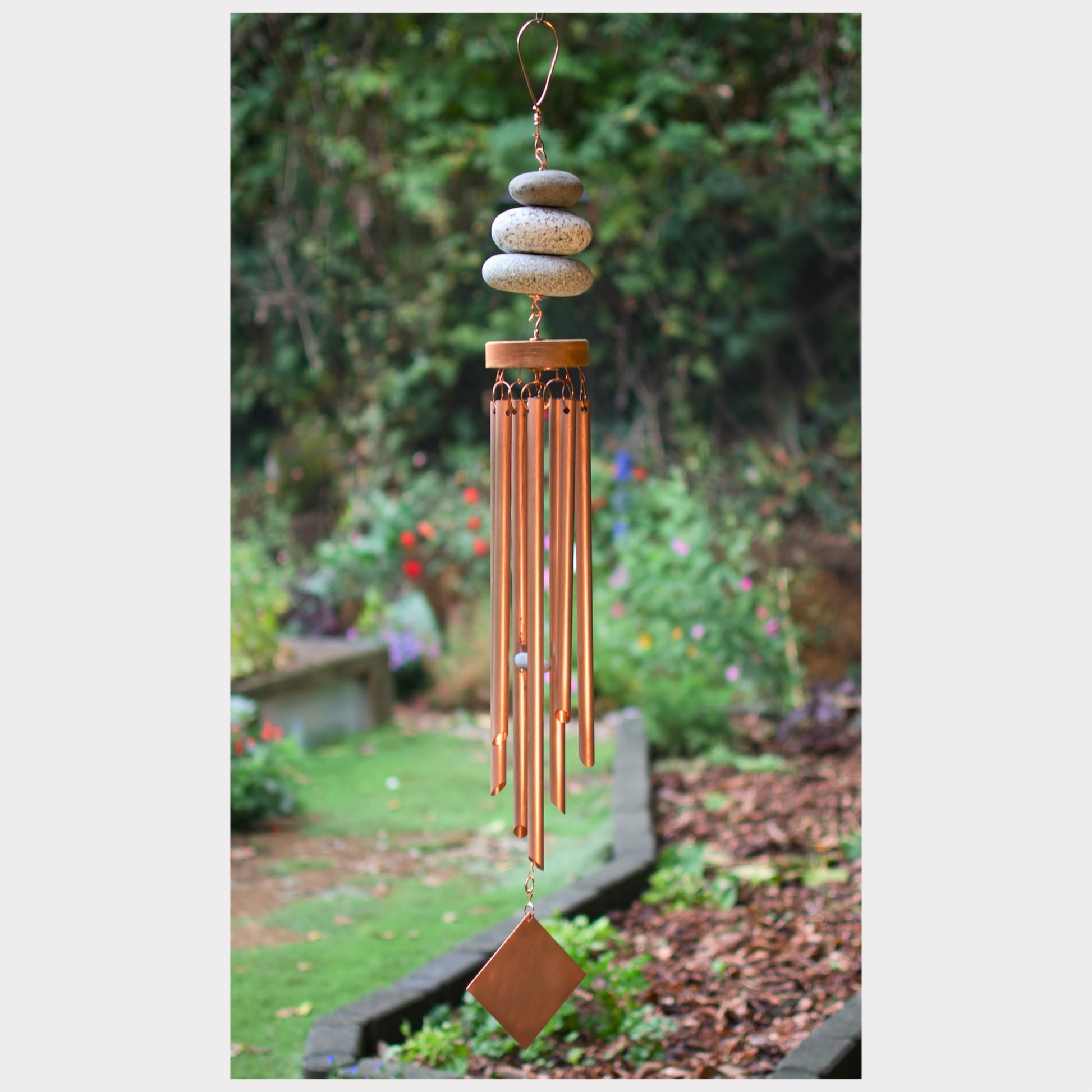 Zen wind chime featuring three natural beach stones and seven genuine copper chimes.