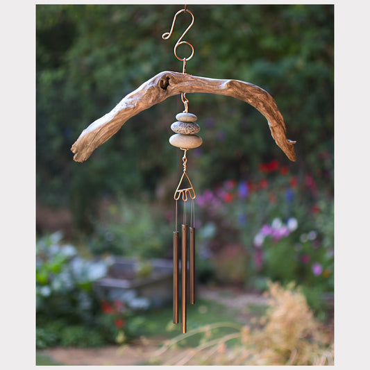 Decorative wind chime with natural elements in a garden setting