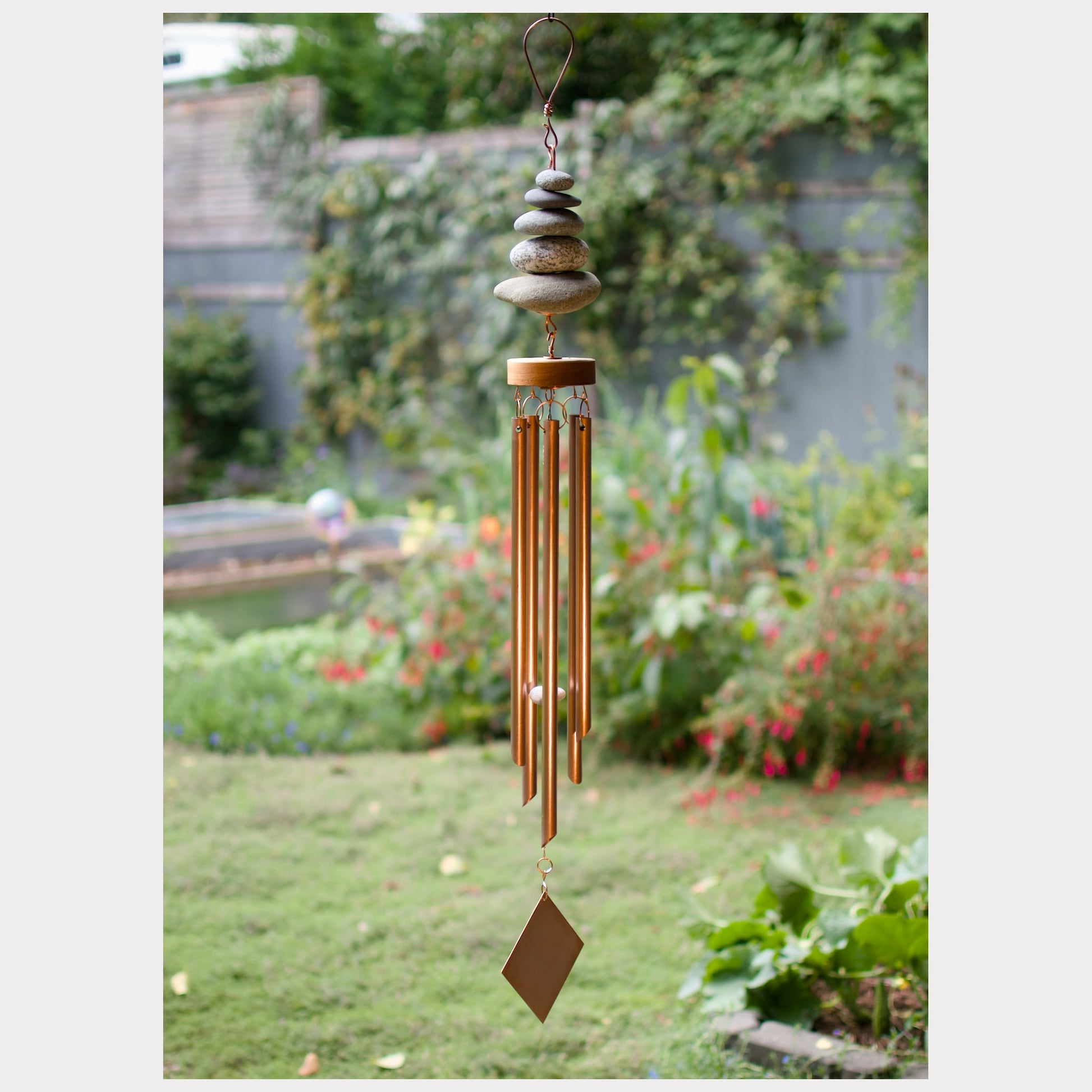 Zen natural beach stone wind chime with five copper chimes.