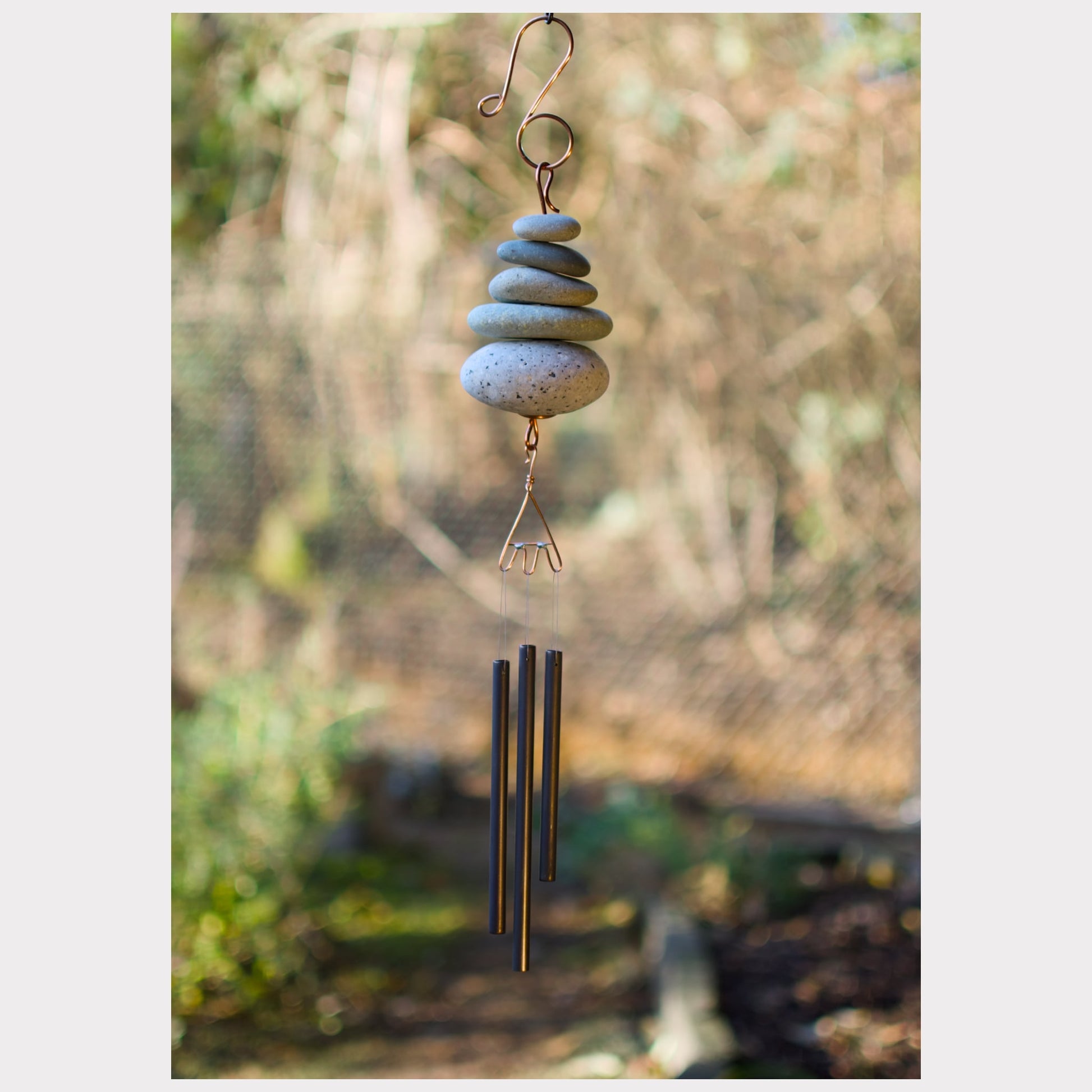 Zen natural beach stone wind chime with three brass chimes.