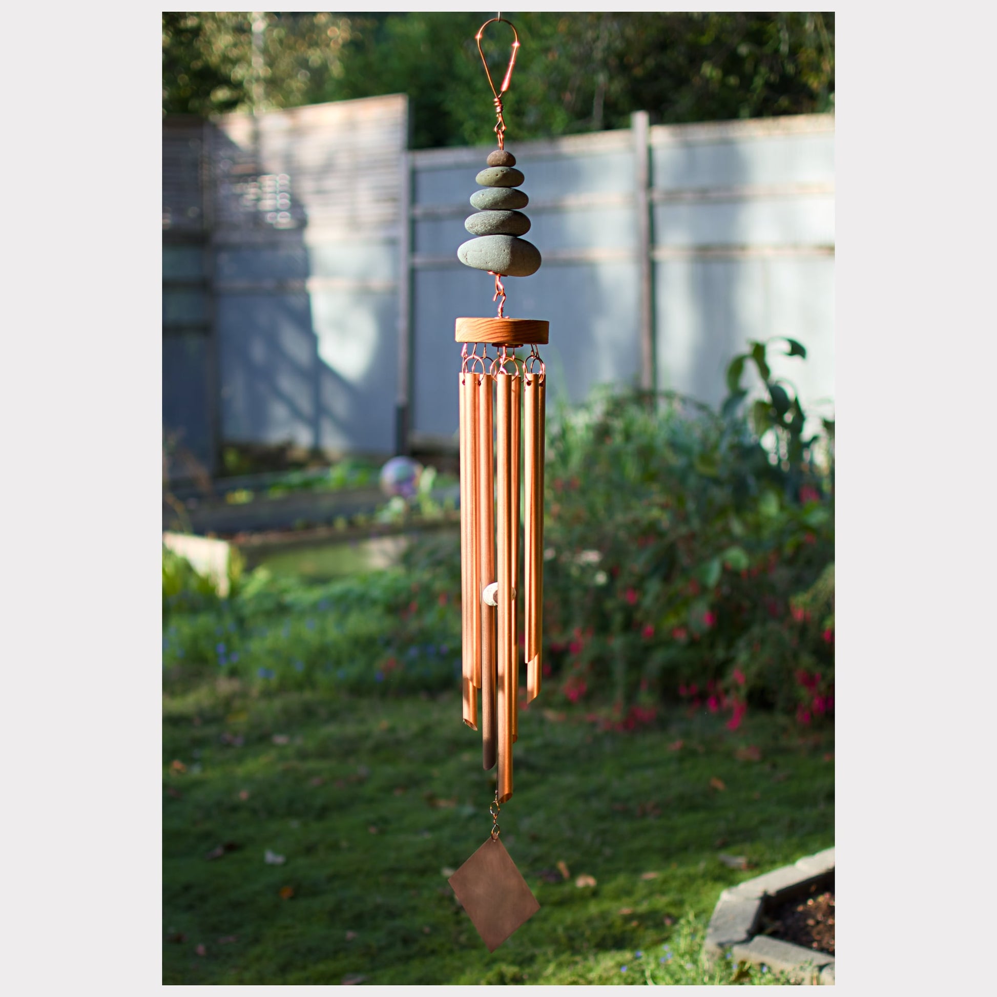 Large handcrafted zen natural beach stone wind chime with 7 copper chimes.