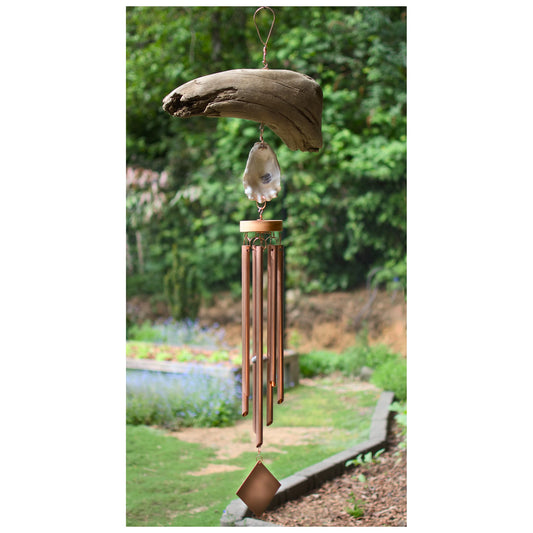 Decorative wind chime with natural elements in a garden setting