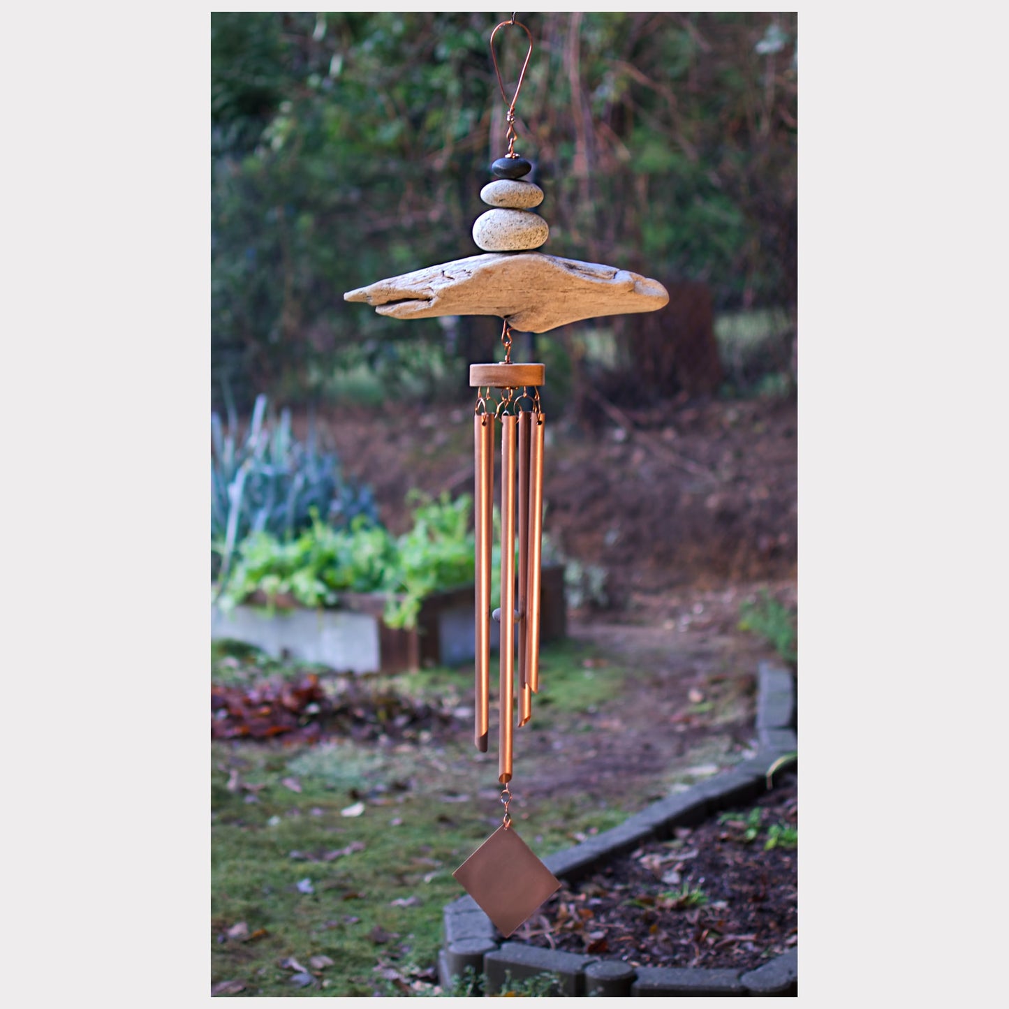 Large zen beach stone and driftwood wind chime with five copper chimers.