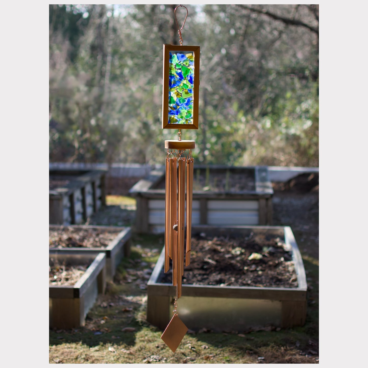 Large kaleidoscope wind chime featuring artist-made beach glass and seven genuine copper chimes.