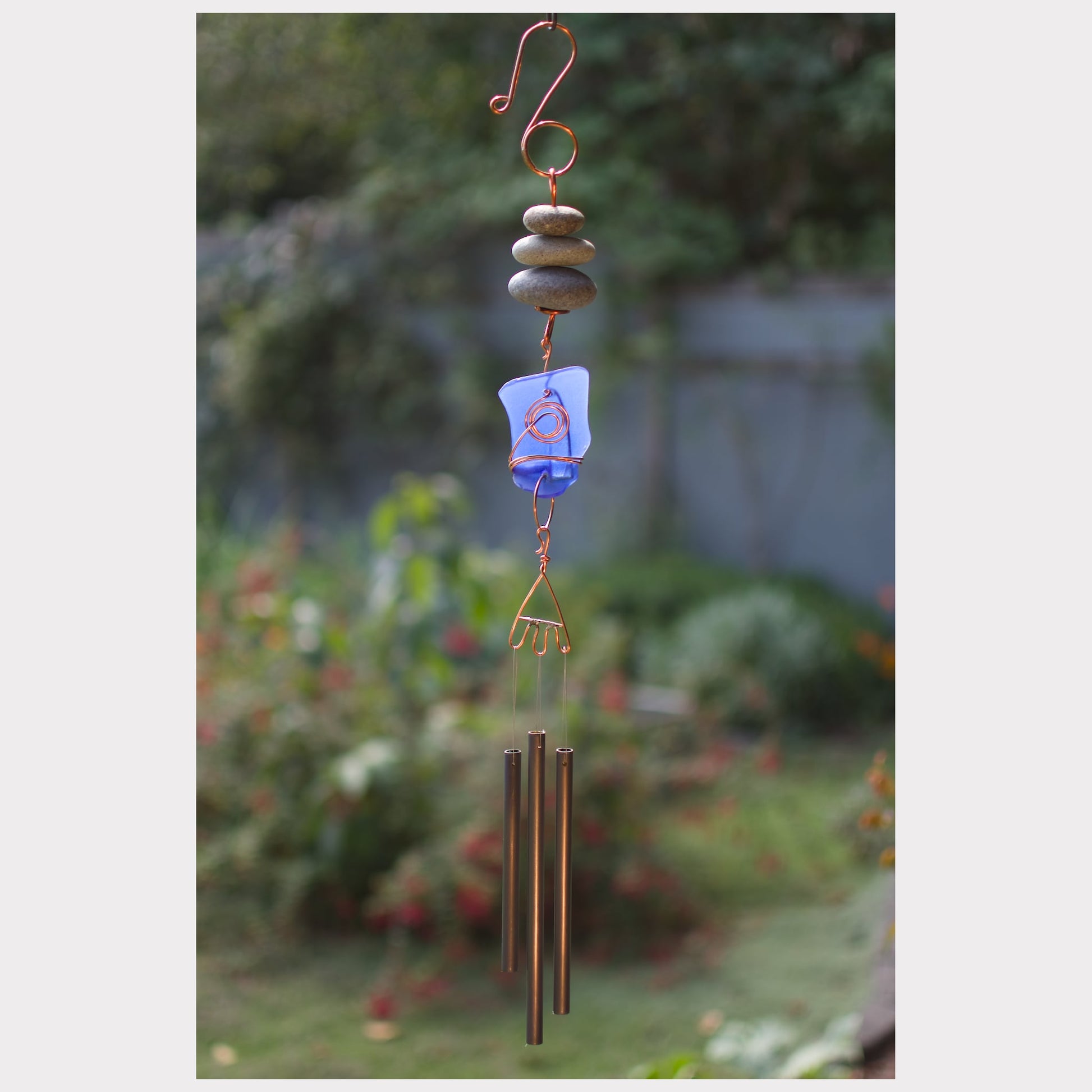 Beach stone and cobalt blue sea glass wind chime.