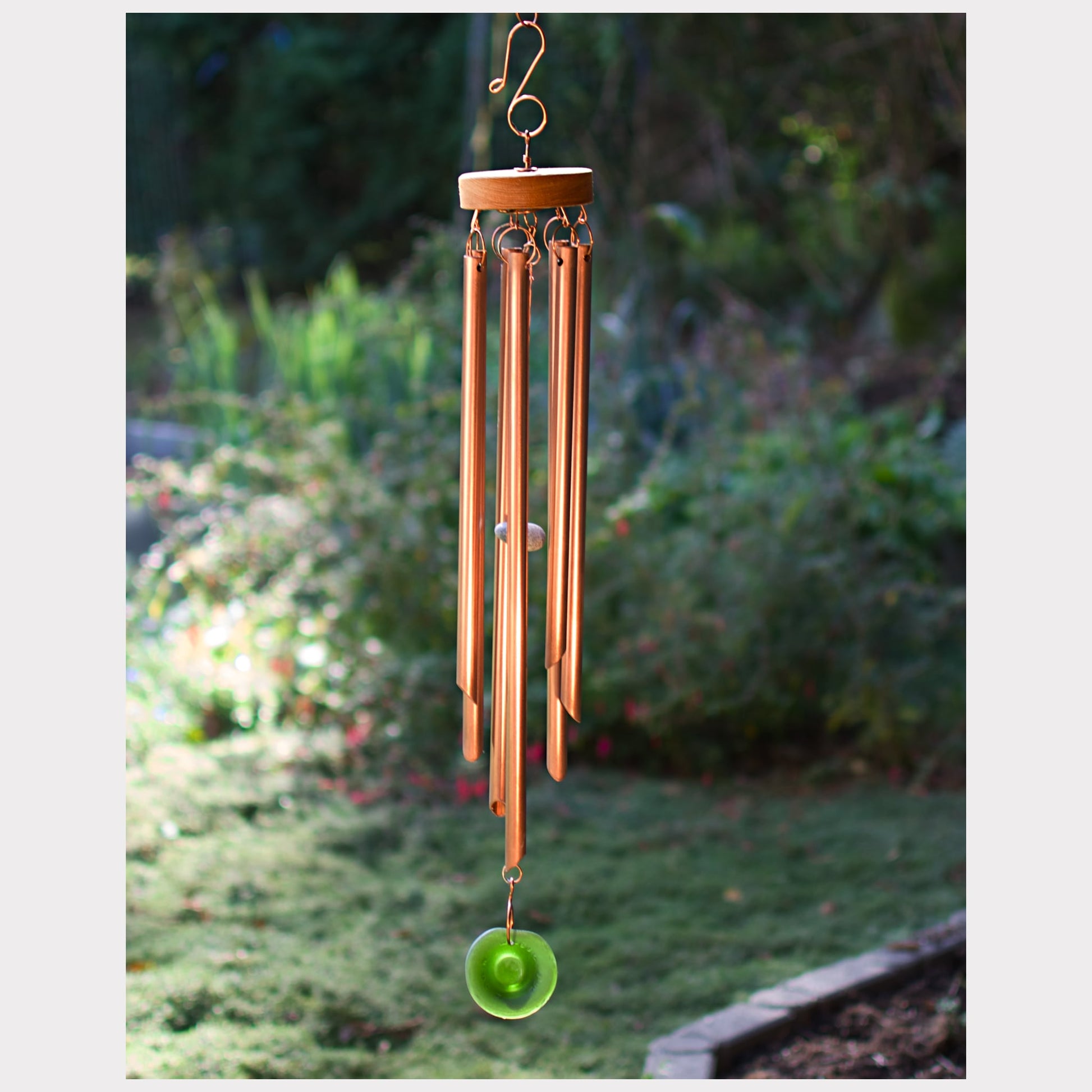 Handcrafted copper wind chime with a sea glass windsail.