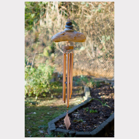 Natural beach stone and driftwood wind chime with five copper chimes.