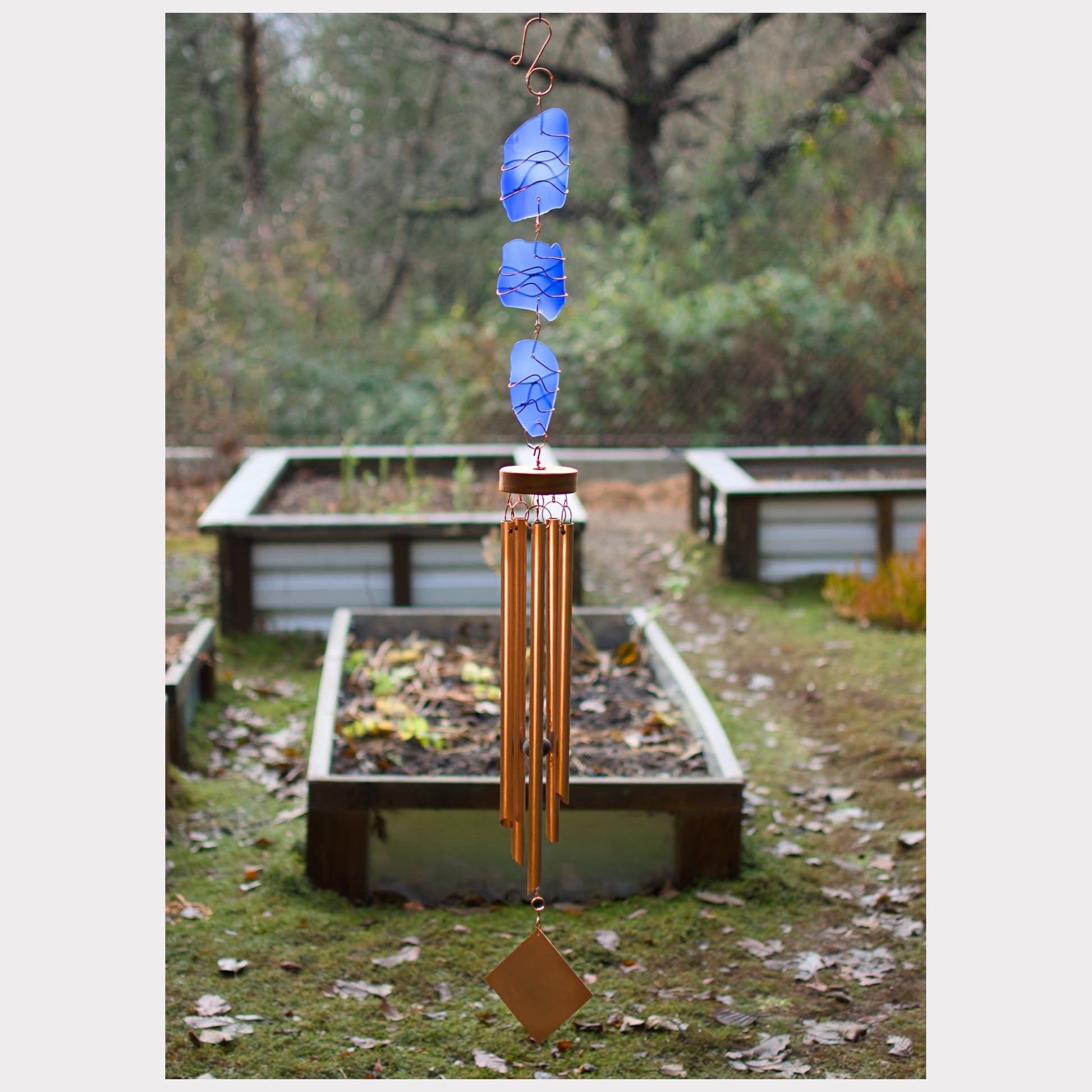 Large cobalt blue beach glass wind chime with five copper chimes.