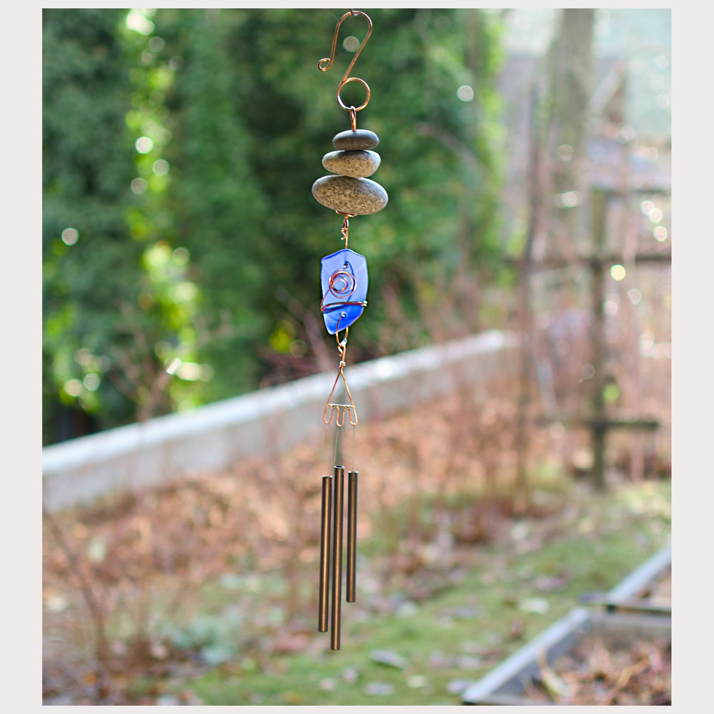 Zen beach stone chime with cobalt blue sea glass.