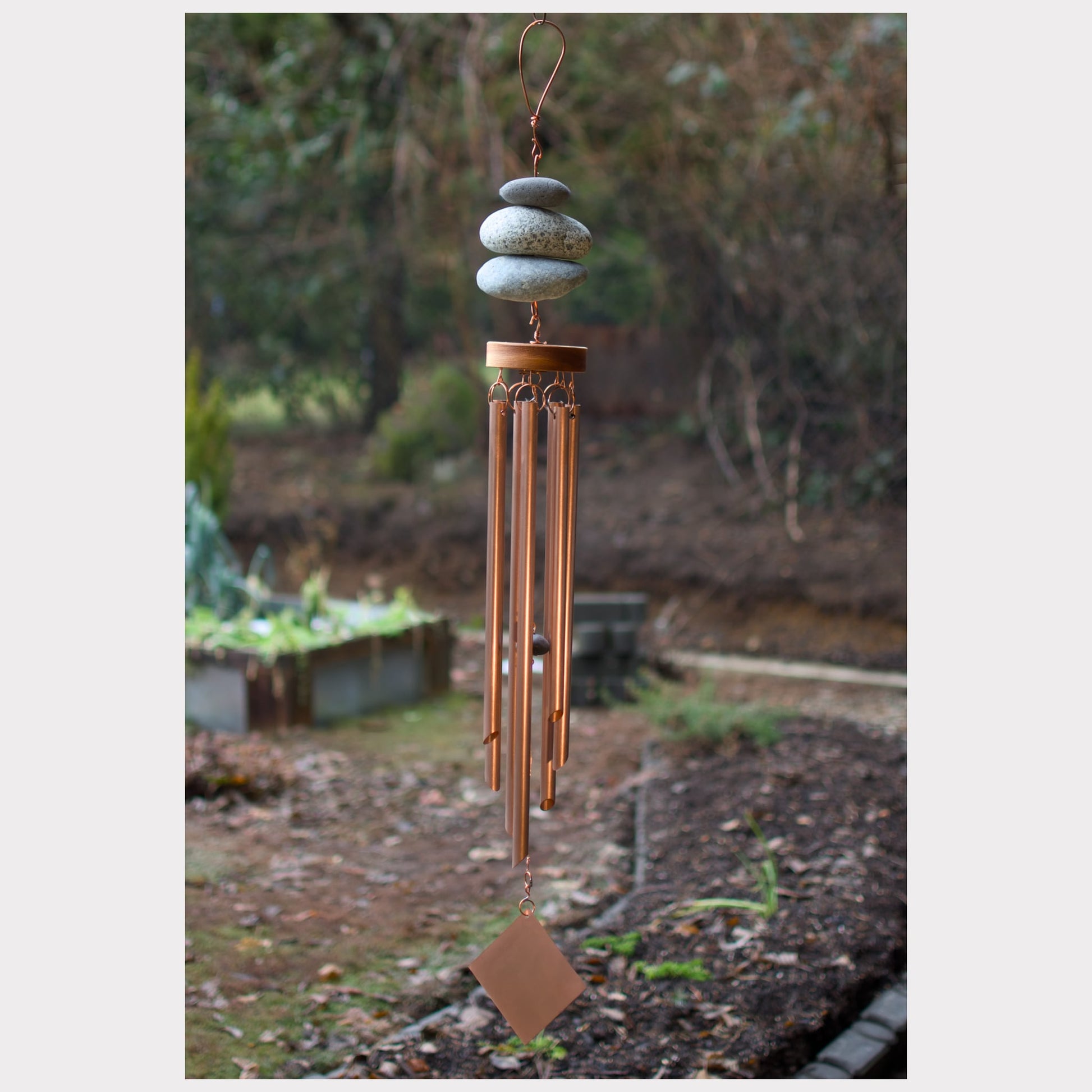 Zen natural beach stone wind chime with seven copper chimes.