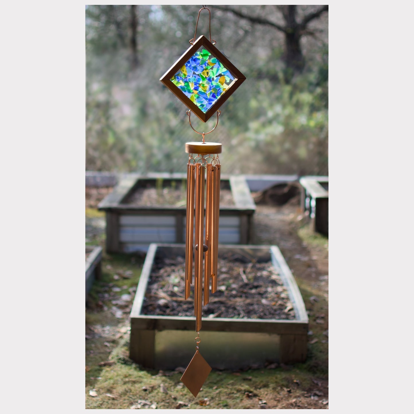 Large kaleidoscope wind chime featuring artist-made beach glass and seven copper chimes.