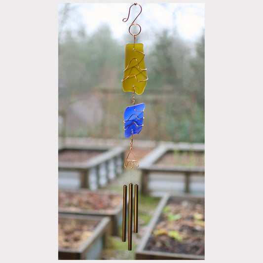 Glass and copper wind chime with three antiqued brass chimes.