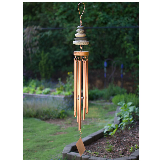 Decorative wind chime with stones hanging in a garden setting
