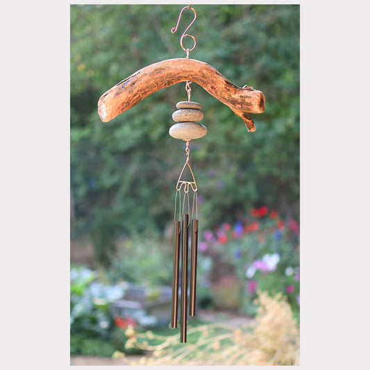 Decorative wind chime with natural elements in a garden setting