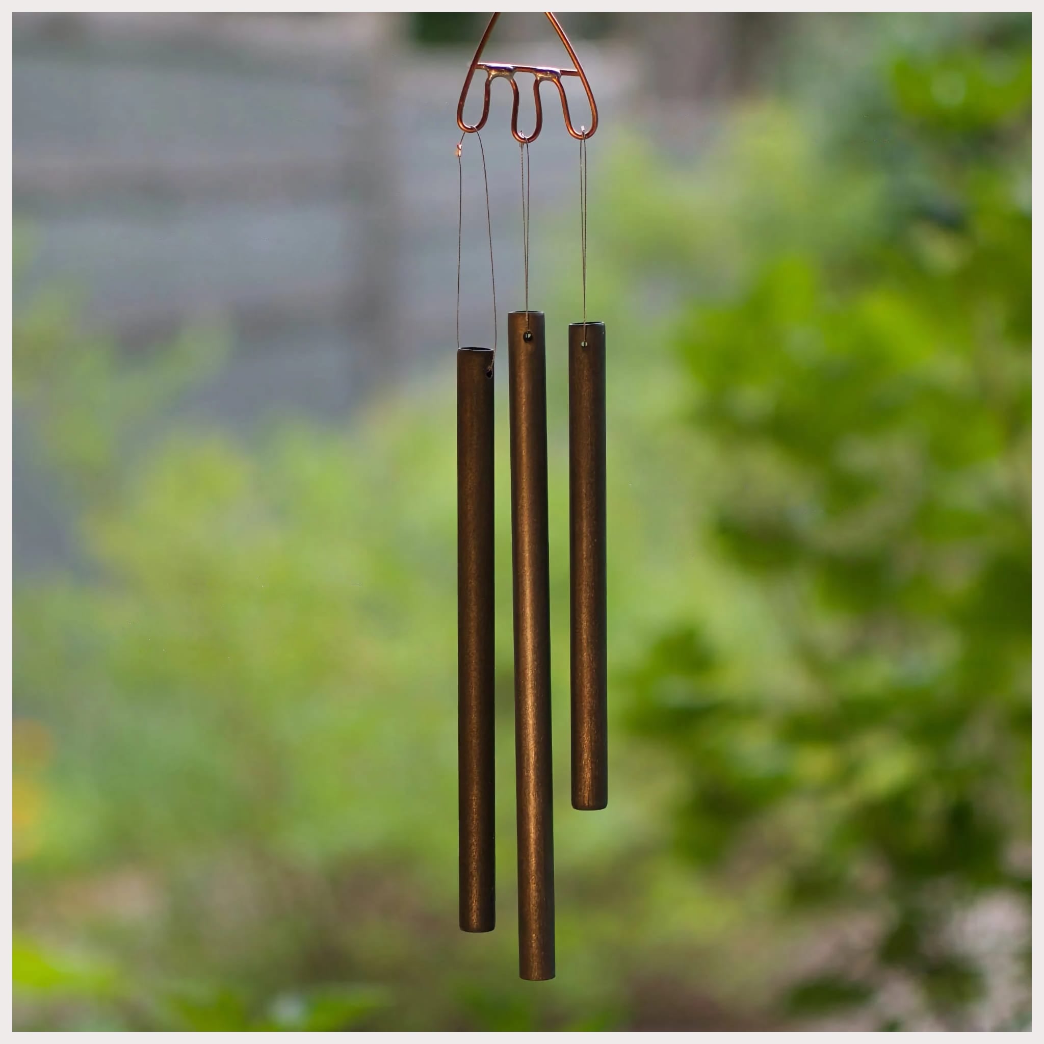 Handmade antiqued brass chimes, made by Coast Chimes.