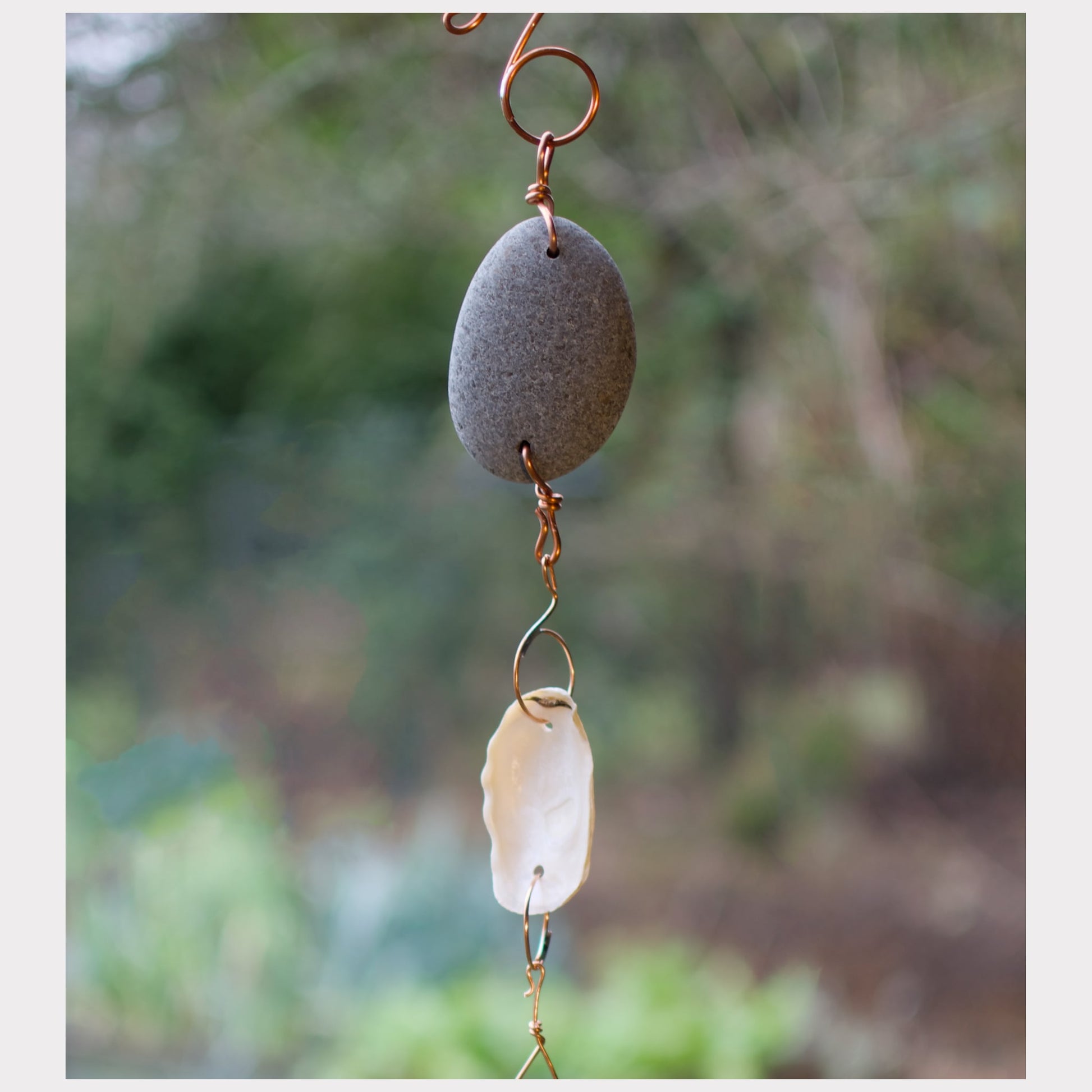 detail, zen beach stone and oyster shell wind chime